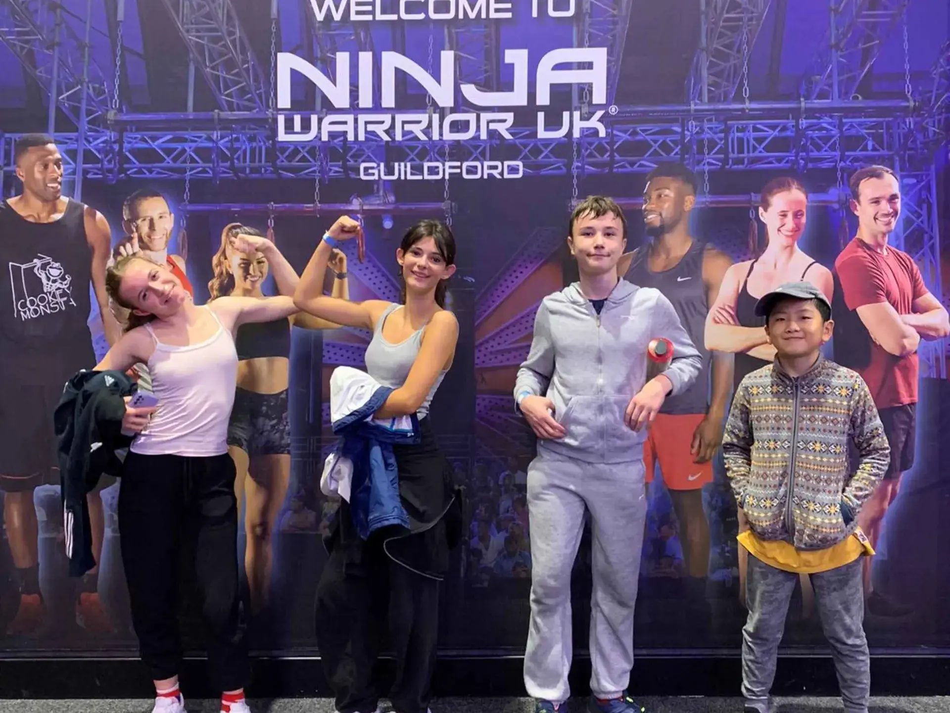 Students posing in front of fitness poster