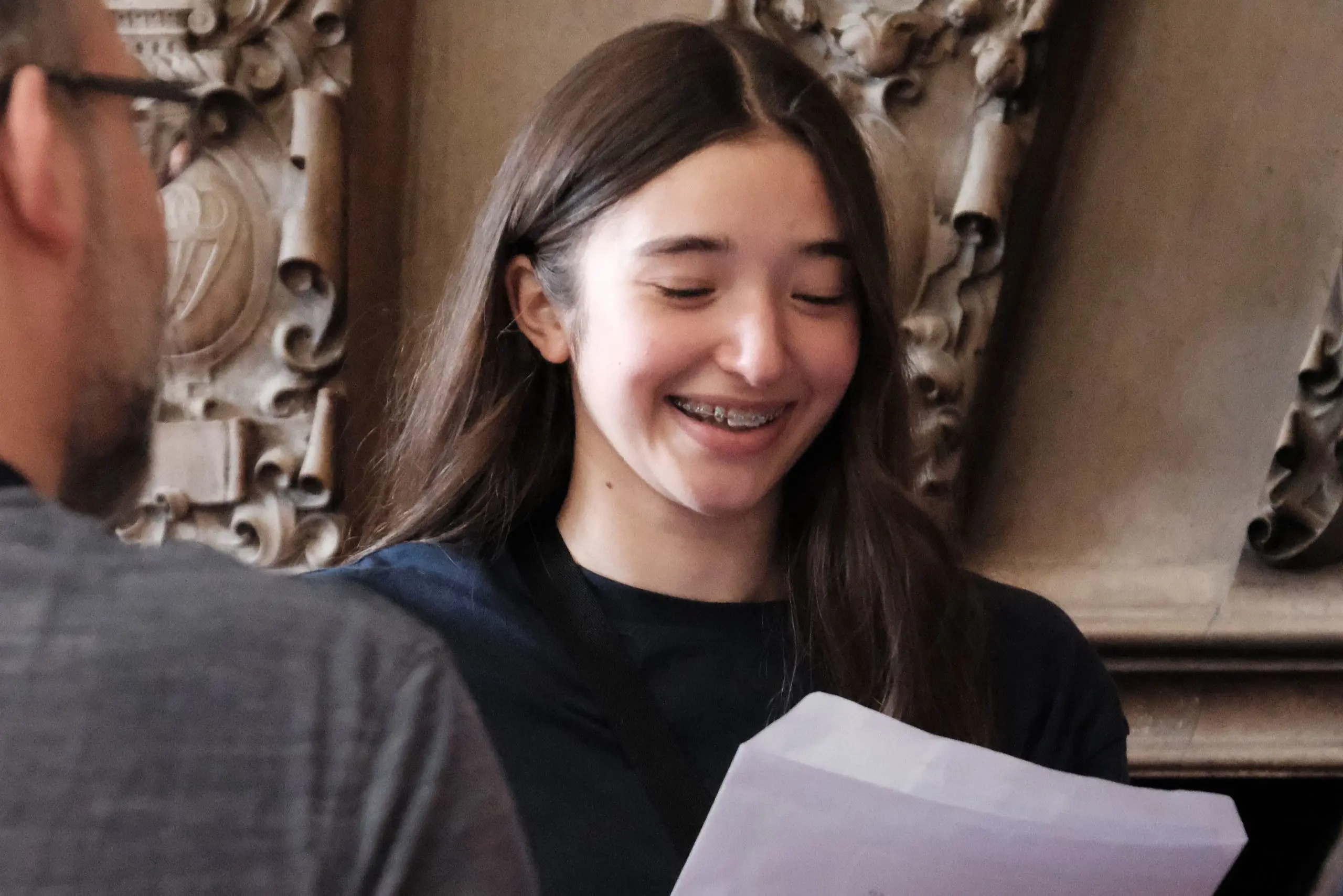Student looking at results and smiling