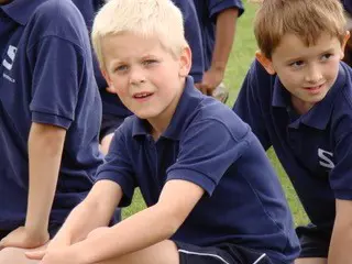Sherfield student sitting on field in PE lesson