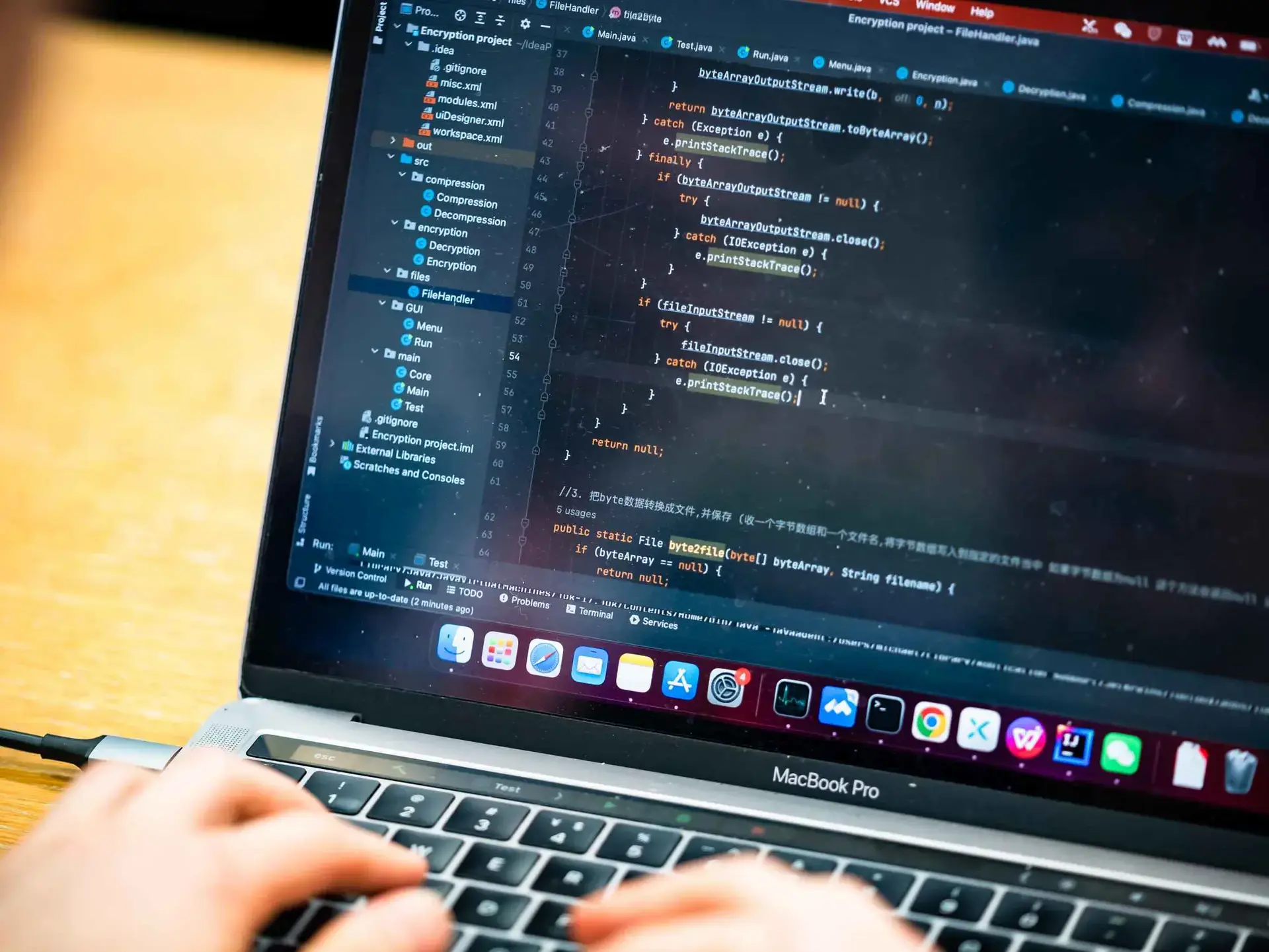 Person coding on a laptop