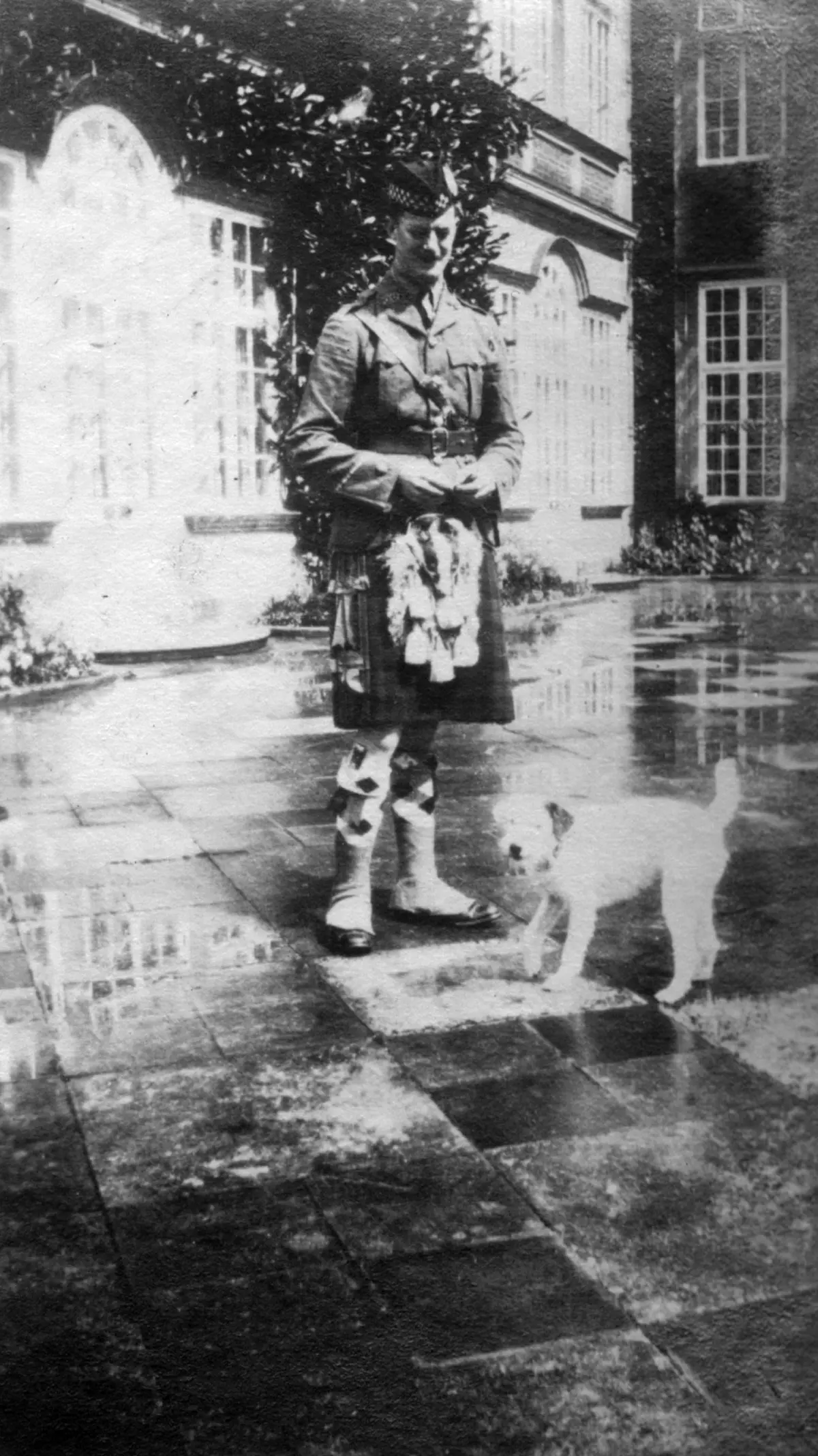 Black and white photo of man in kilt
