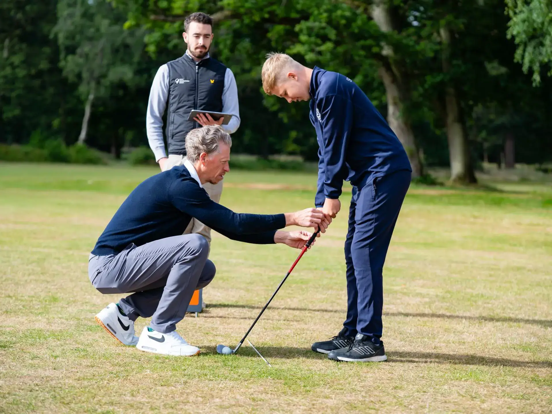 Golf instructor correcting technique