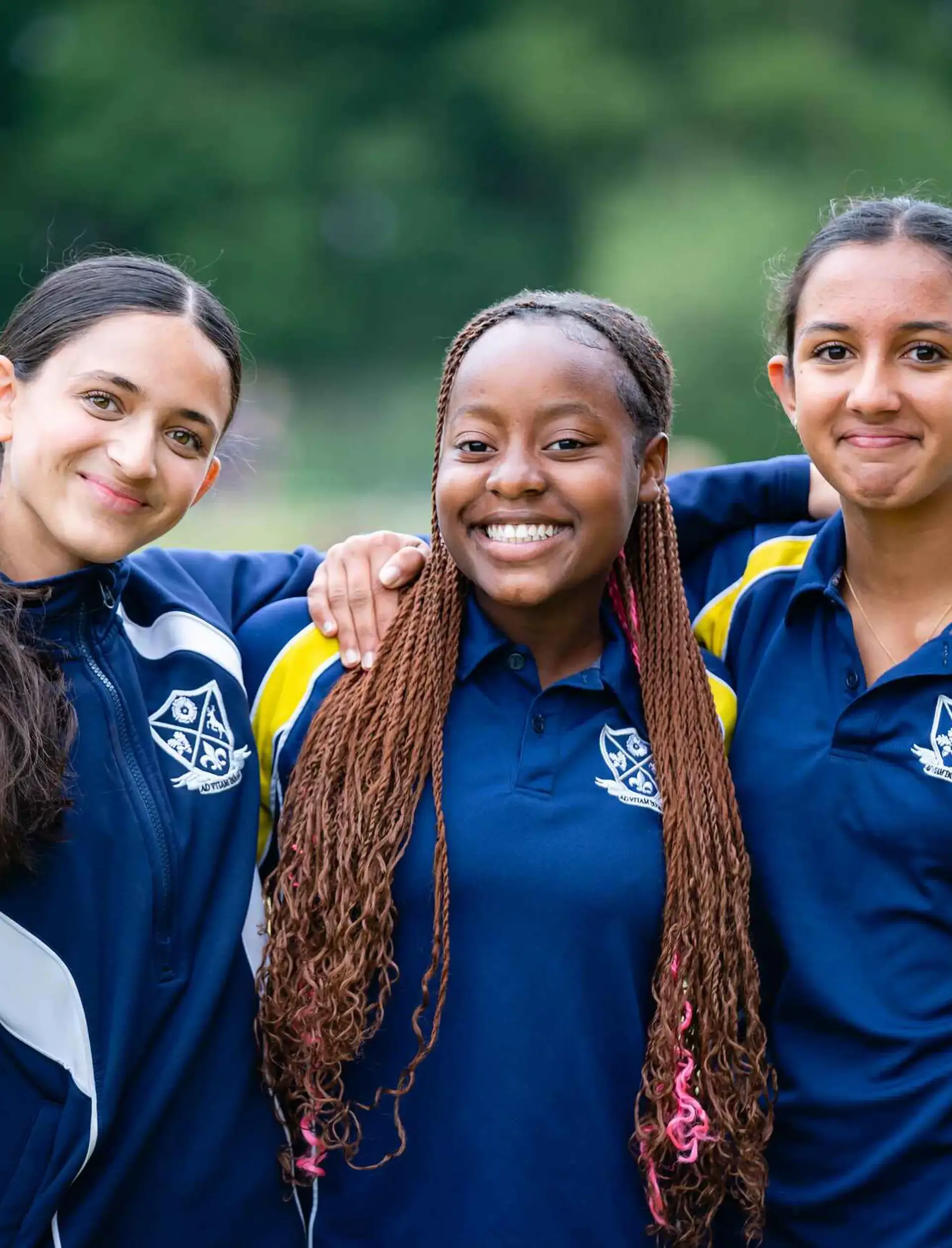 Three students smiling together