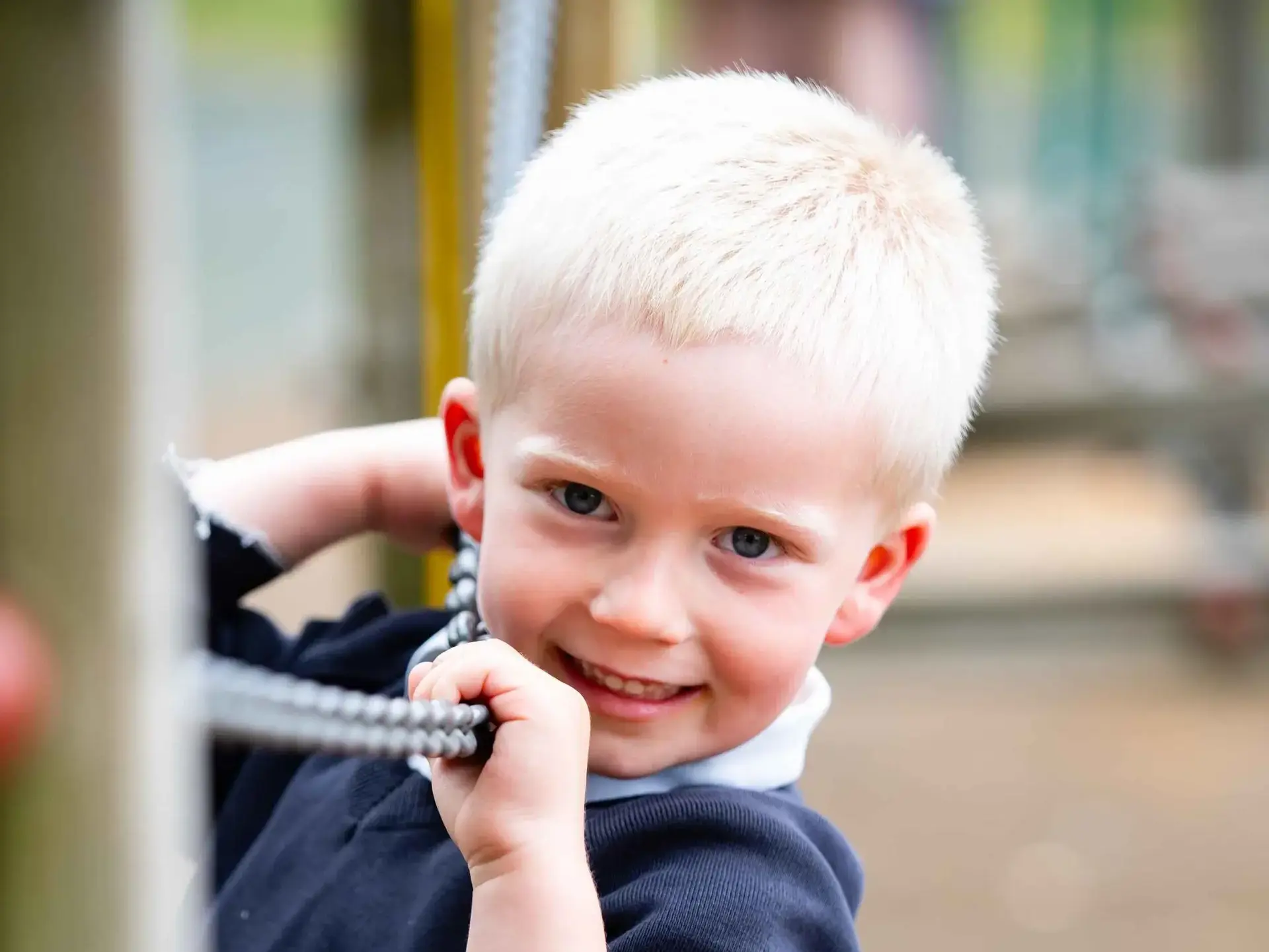 Student gripping chain and smiling