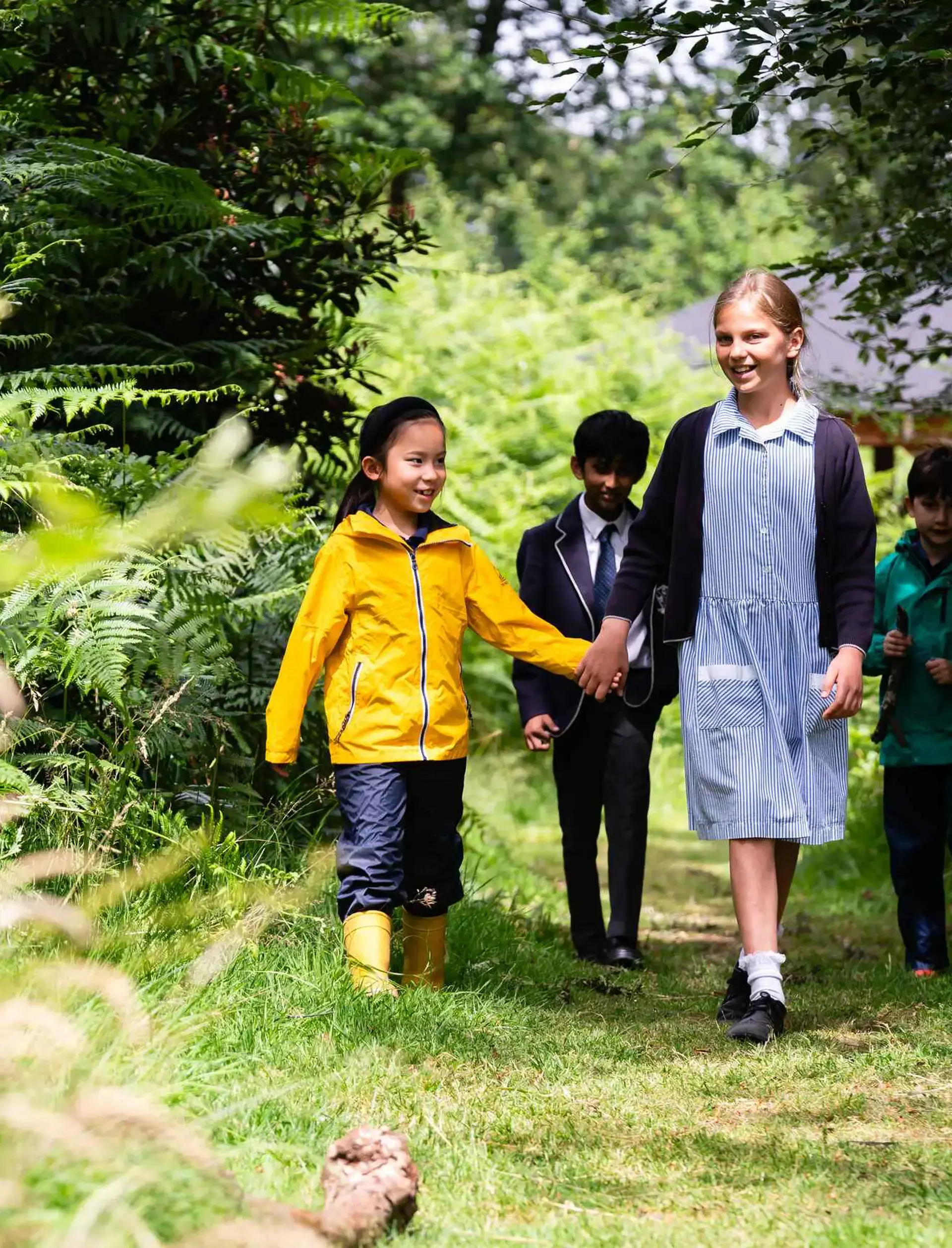 Students walking through wooded area