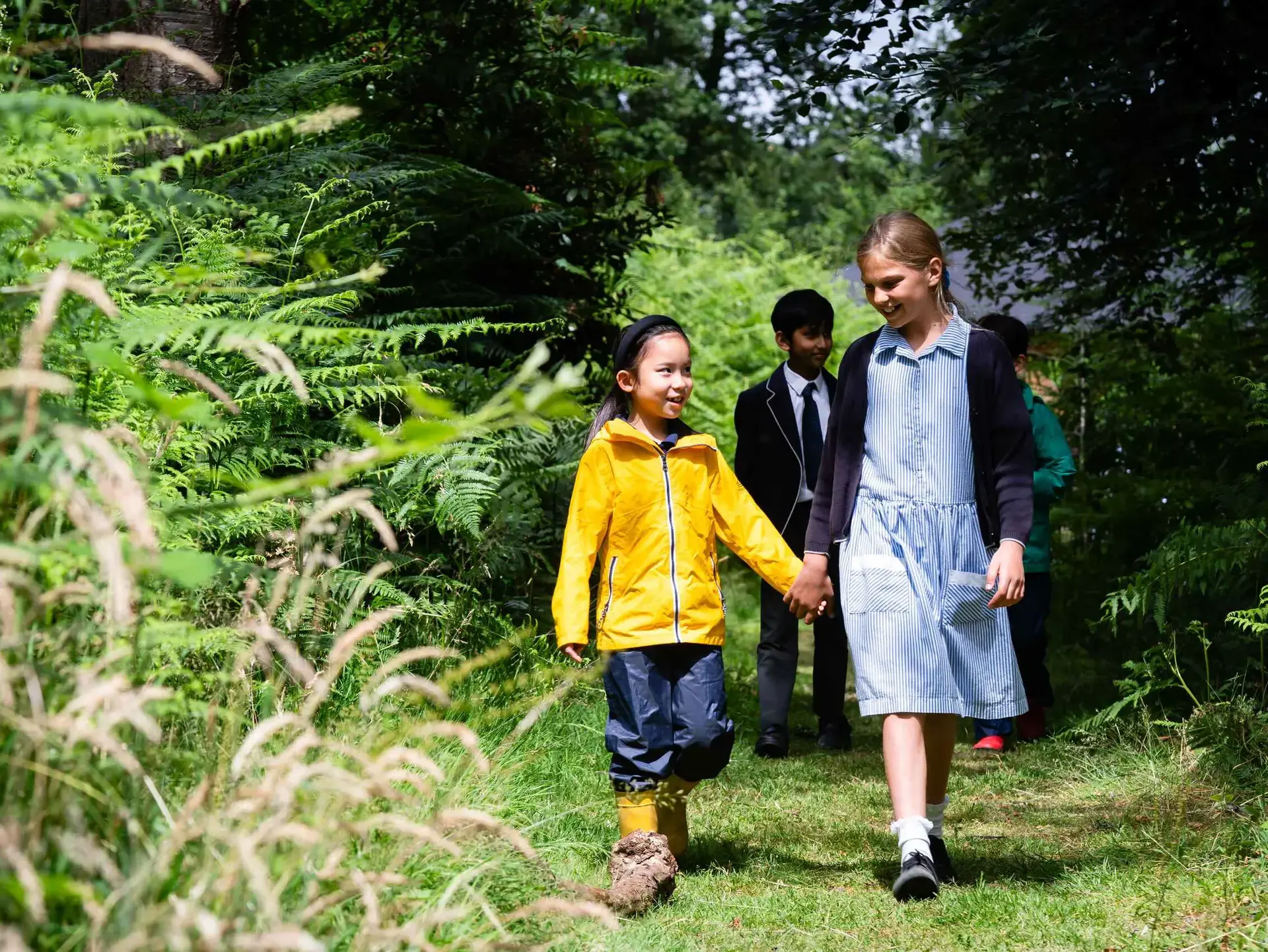 Students walking through copse