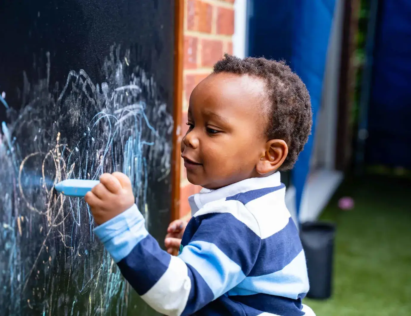 Student drawing on chalkboard