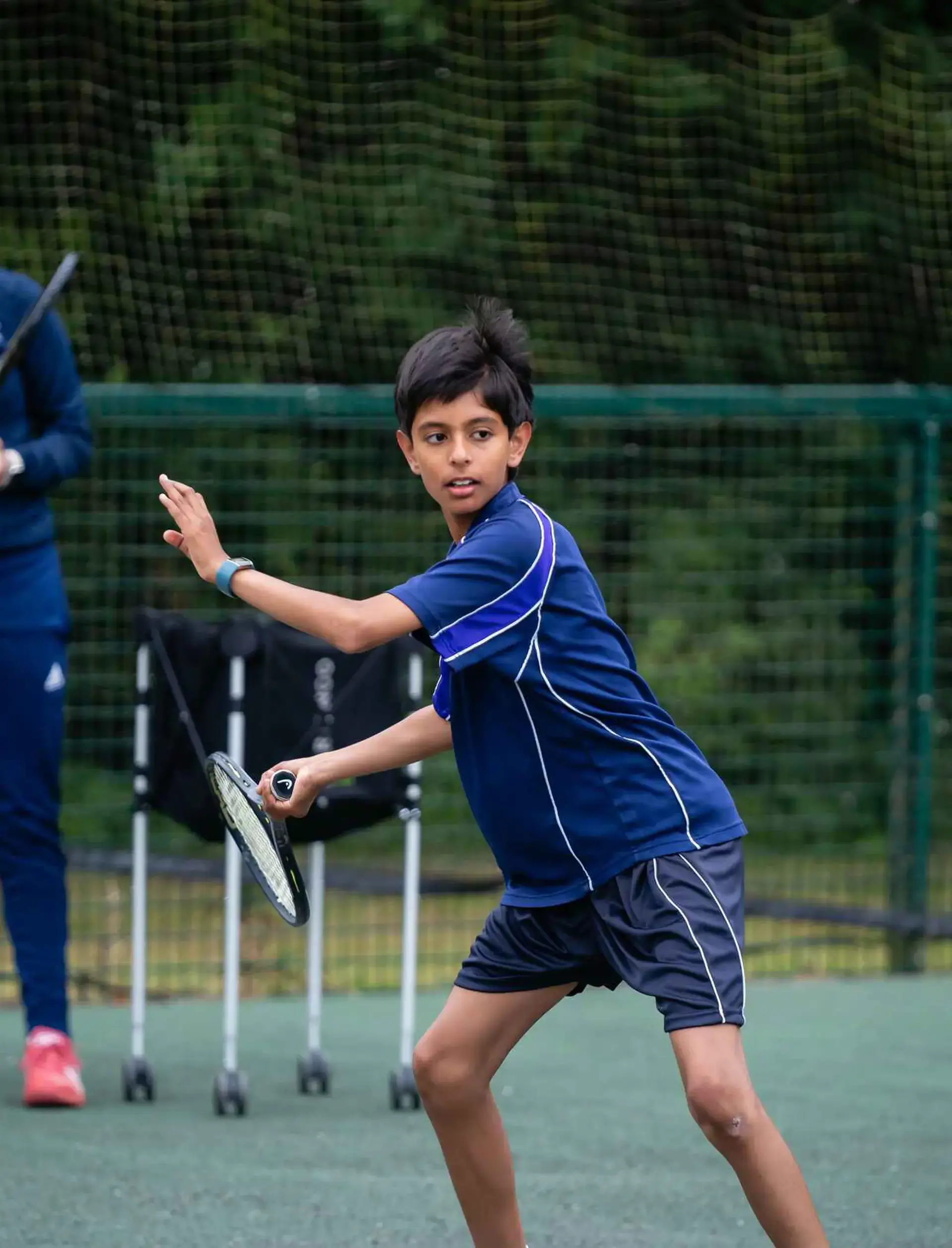 Student playing tennis