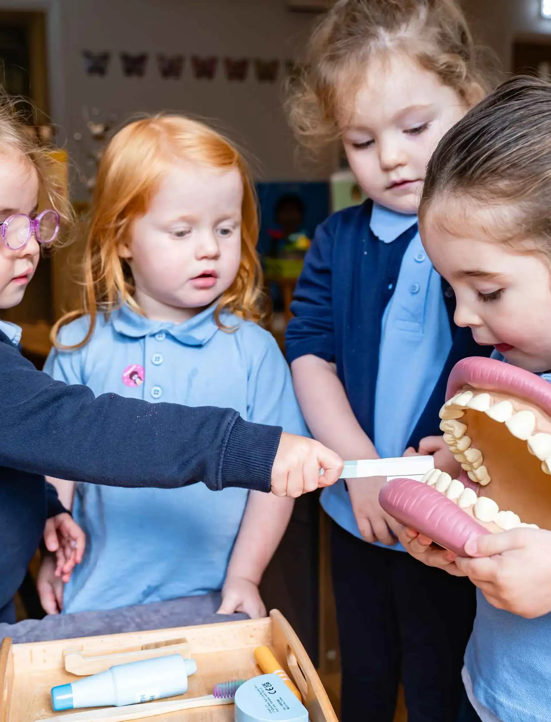 Students examining a large set of teeth