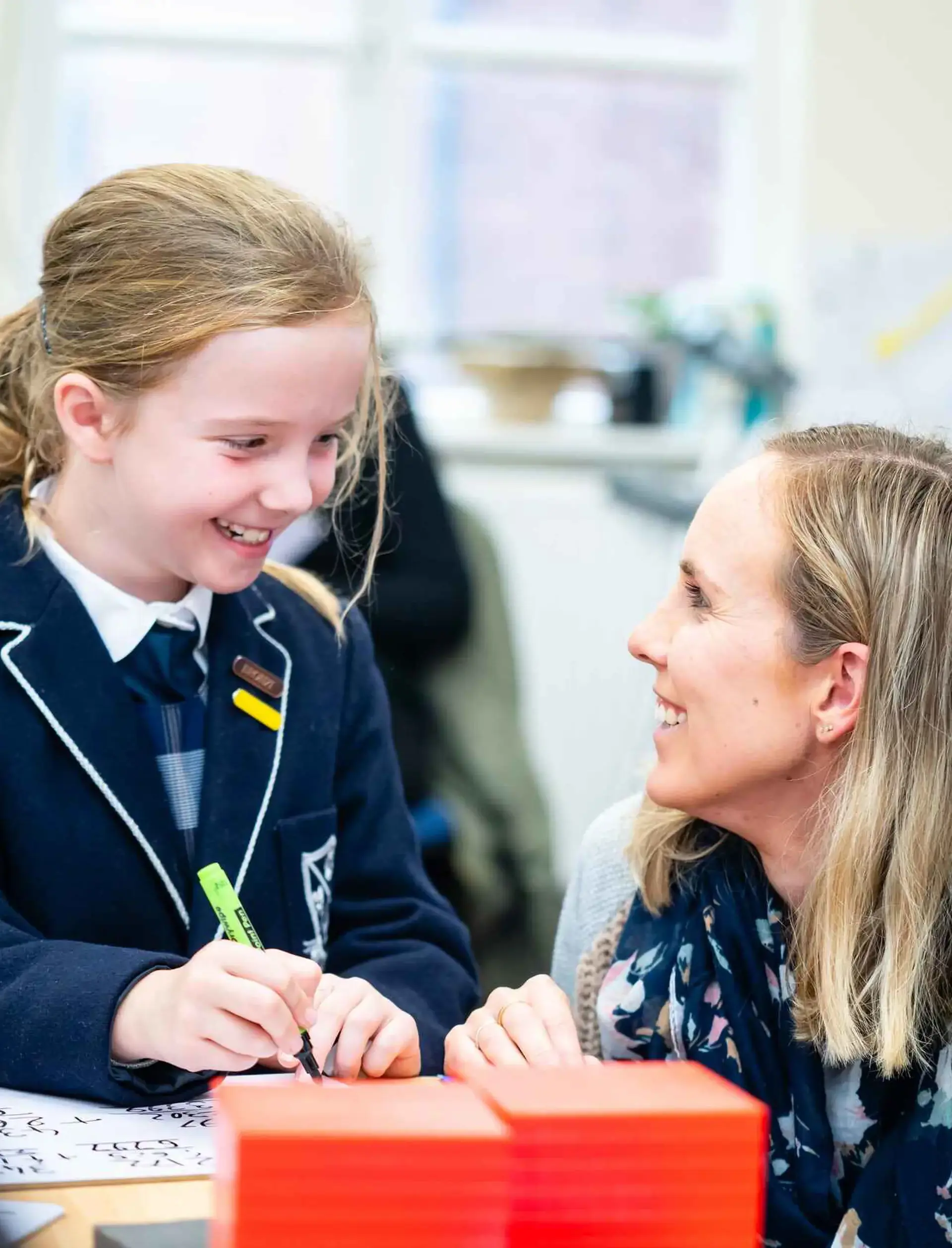 Student smiling down at teacher