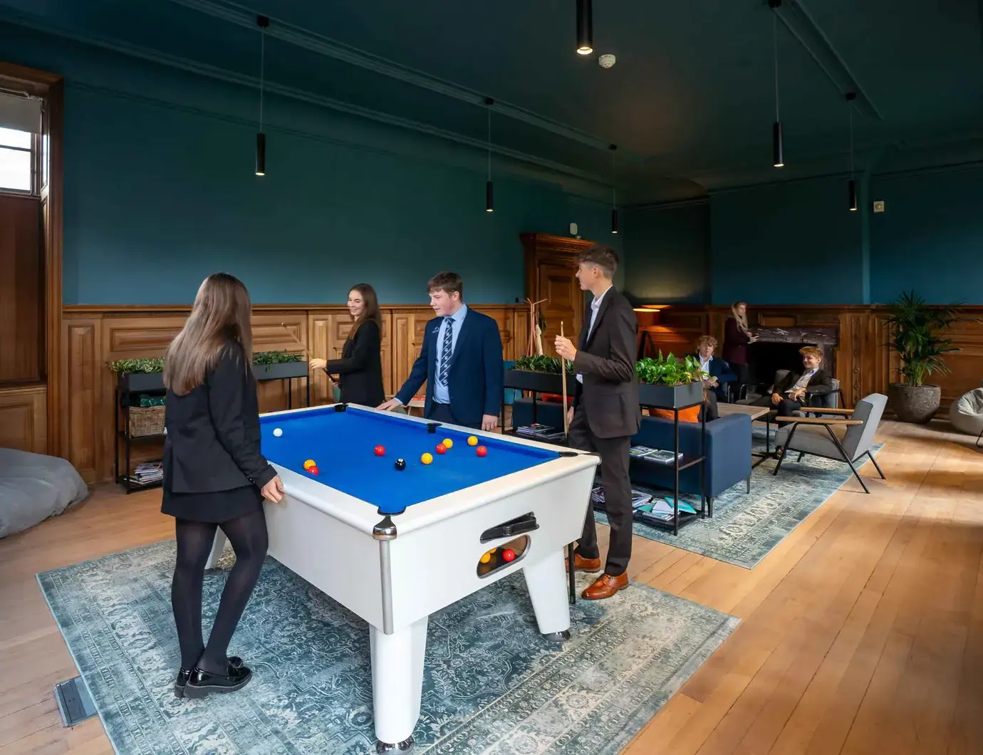 Sixth formers playing pool in lounge