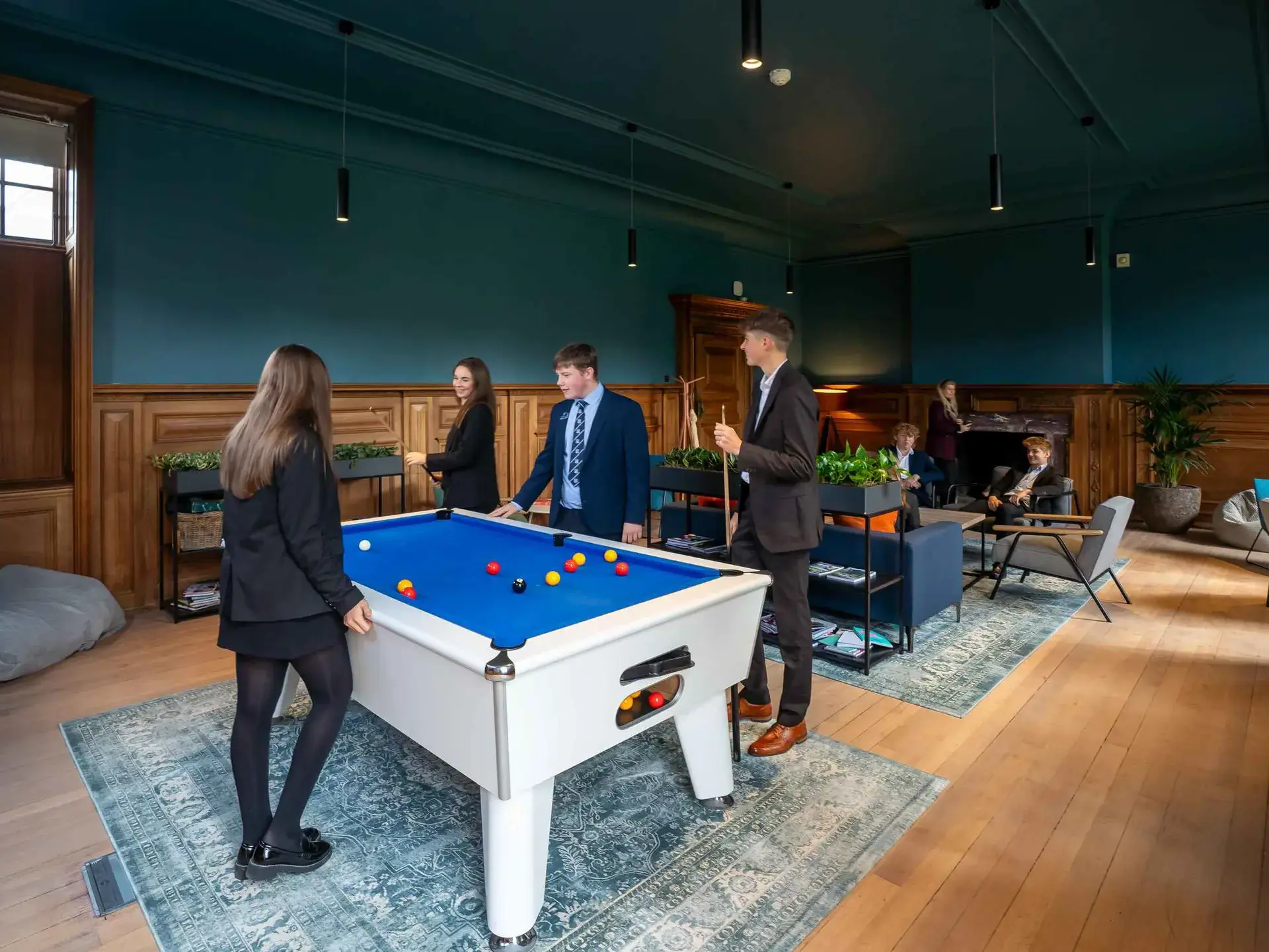 Sixth formers playing pool in lounge