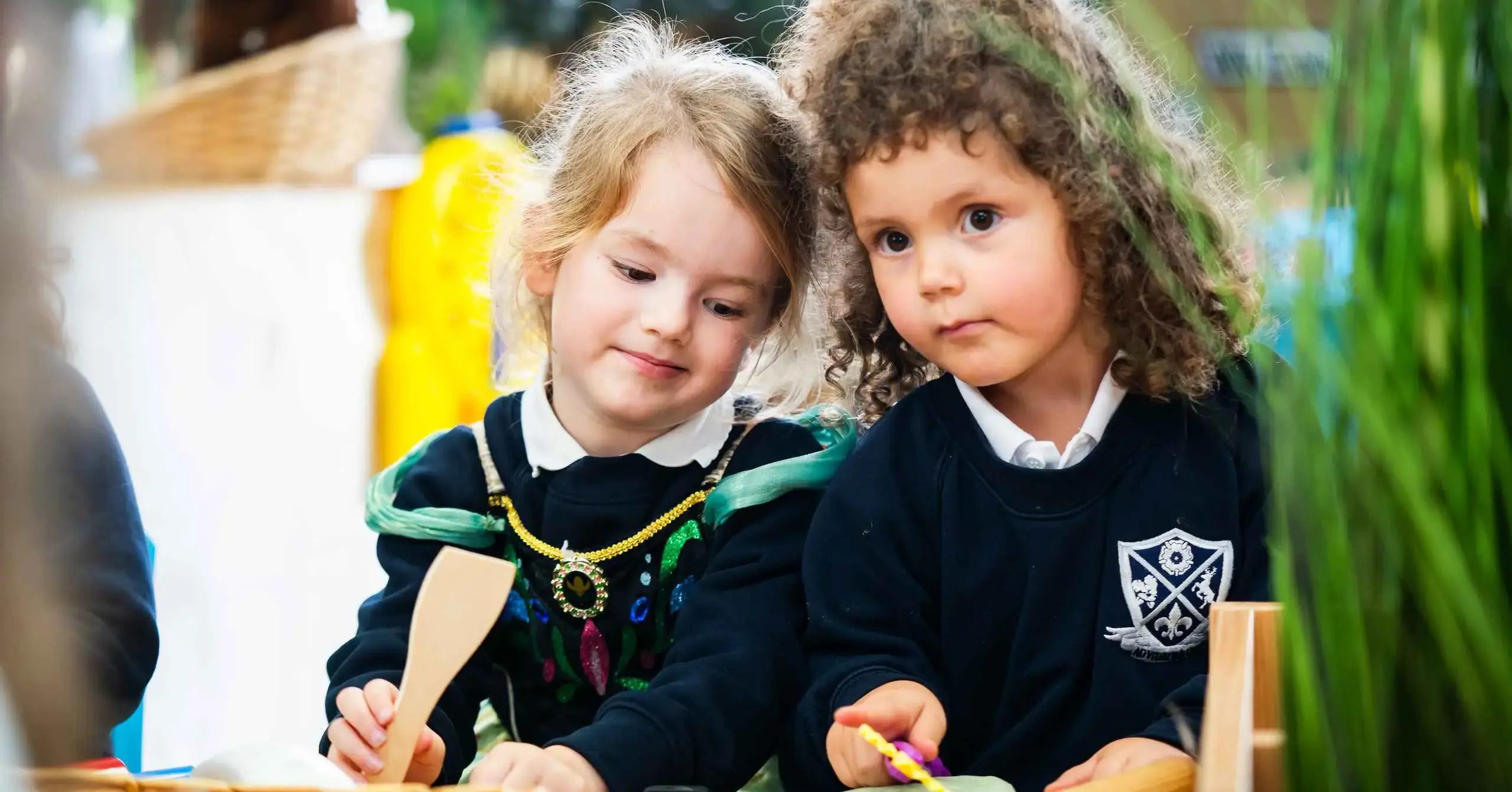 Two early years students sitting together