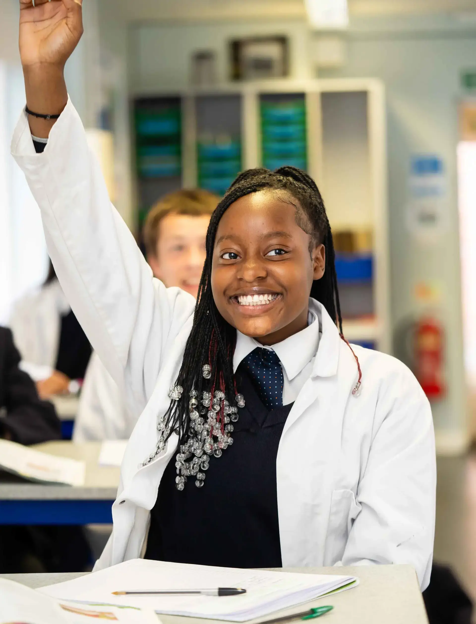 Student raising hand in lesson