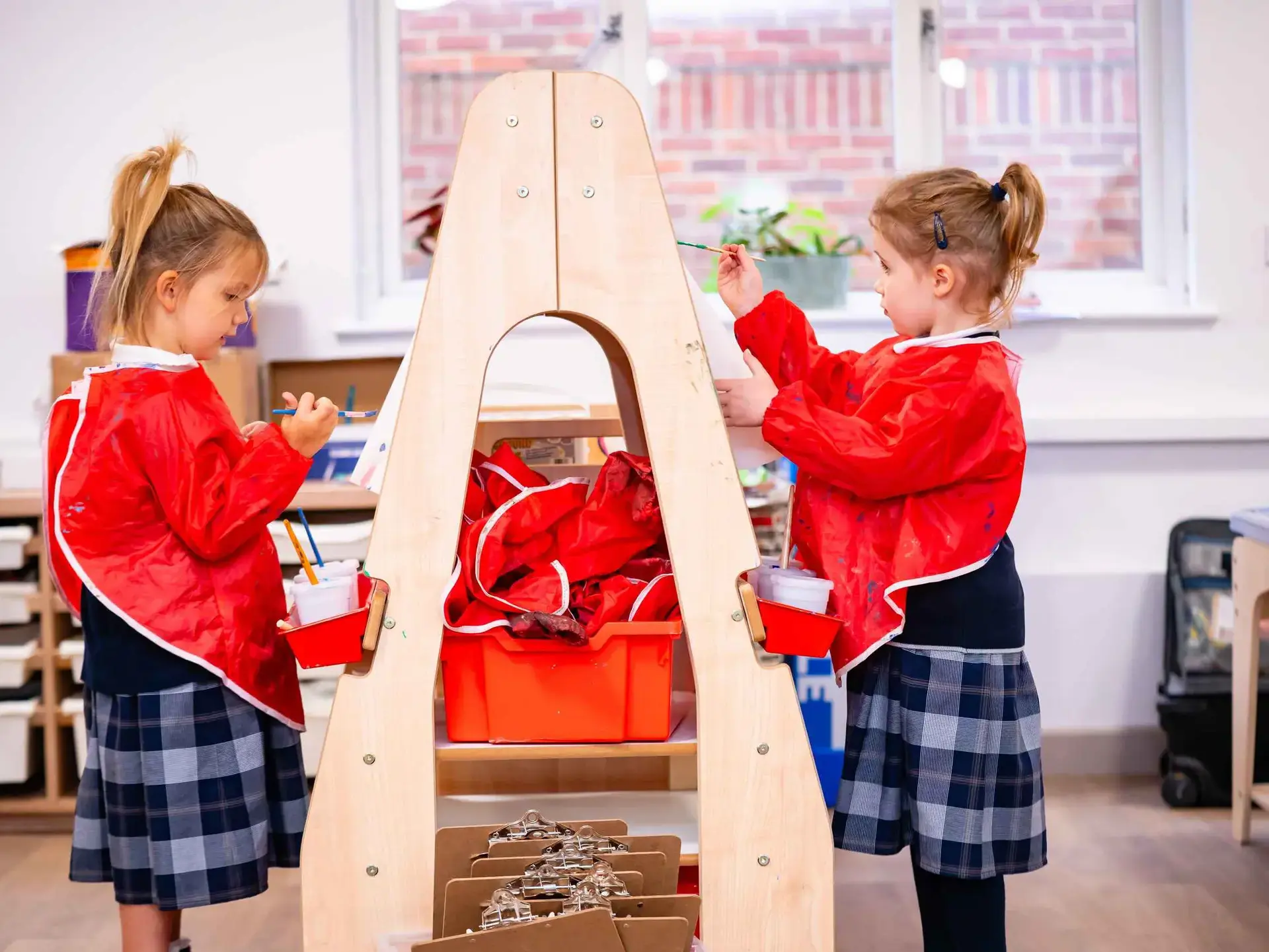 Students painting on back-to-back easels