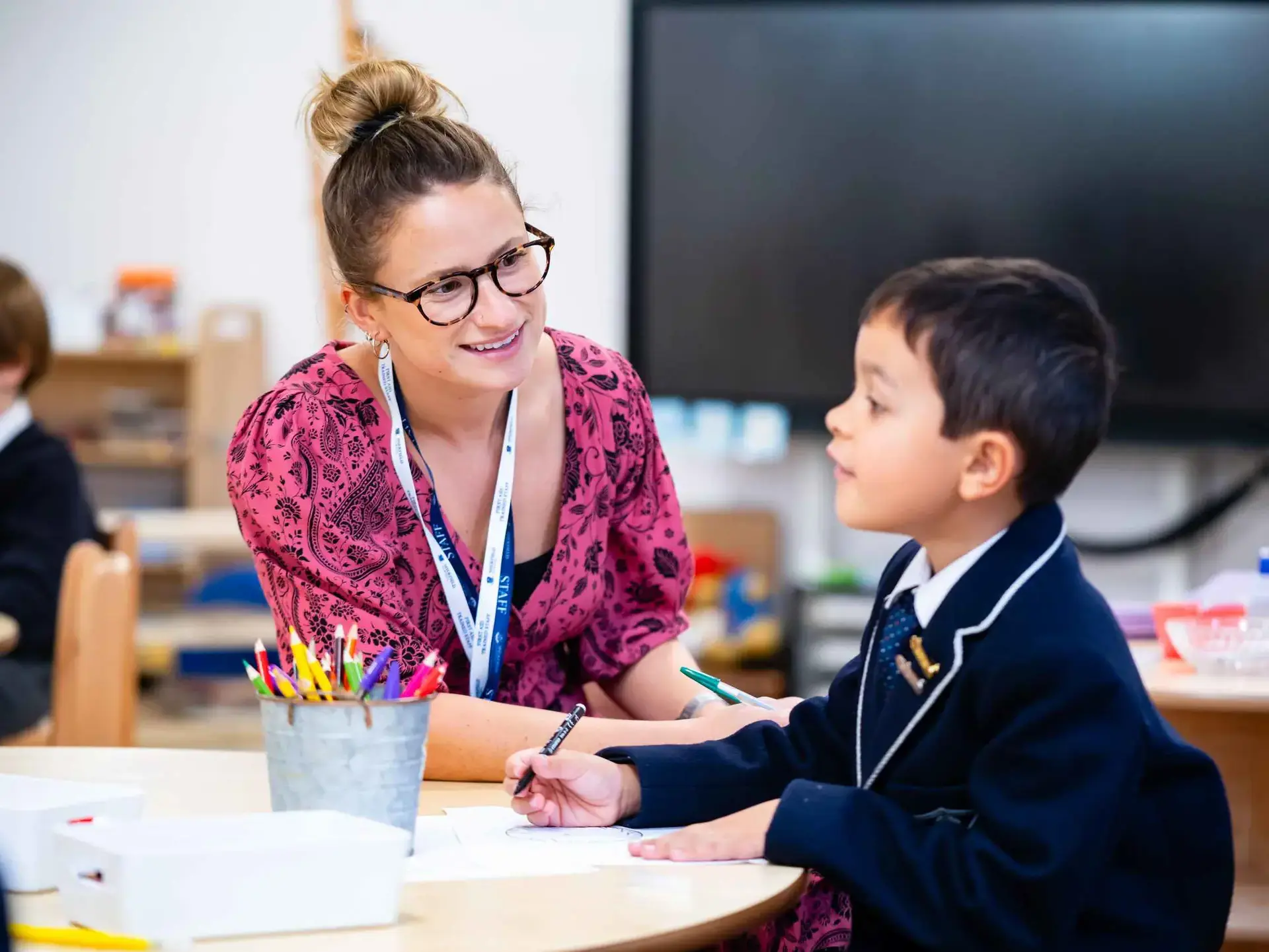 Student and teacher chatting at table