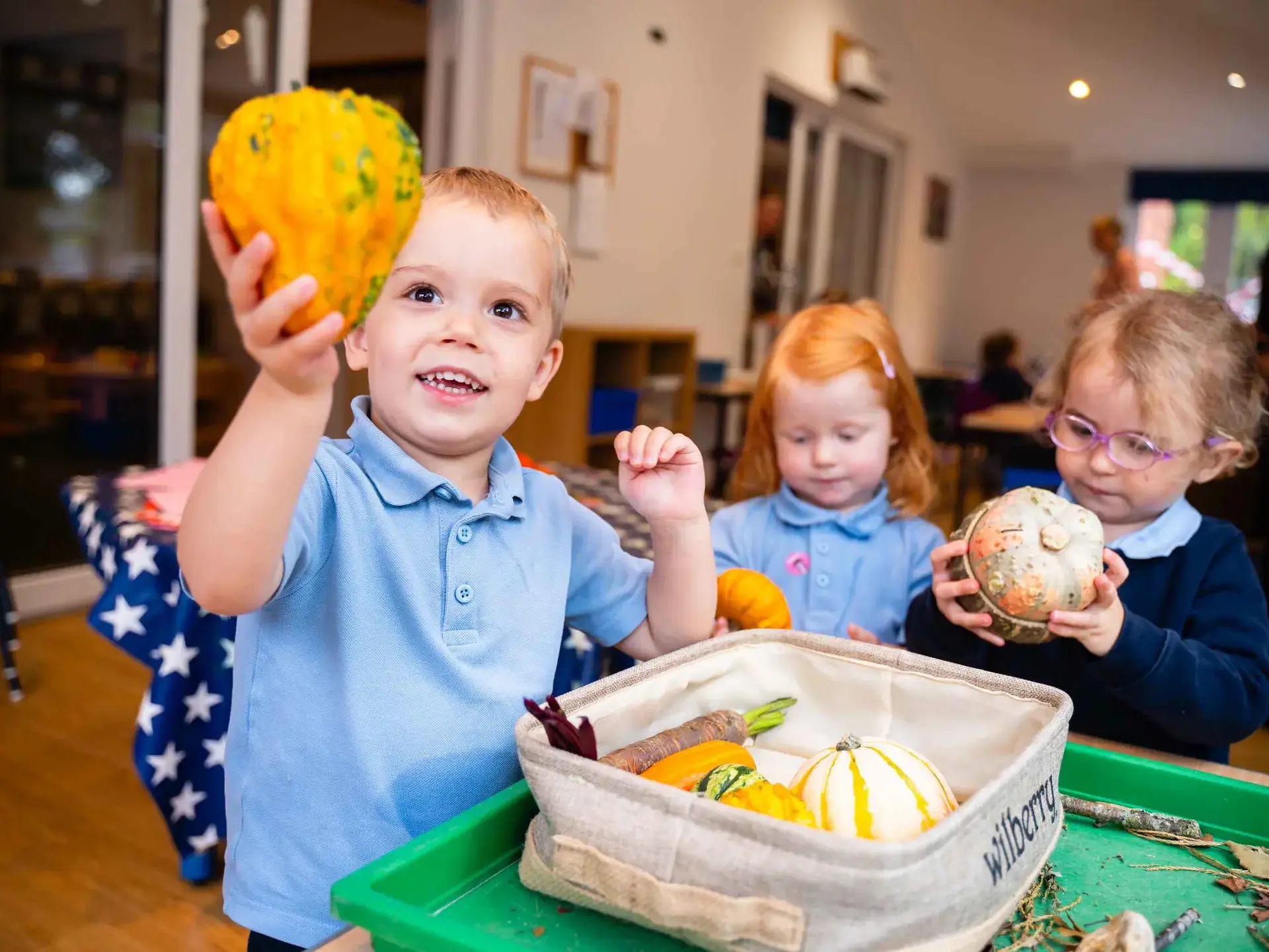 Students holding root vegetables
