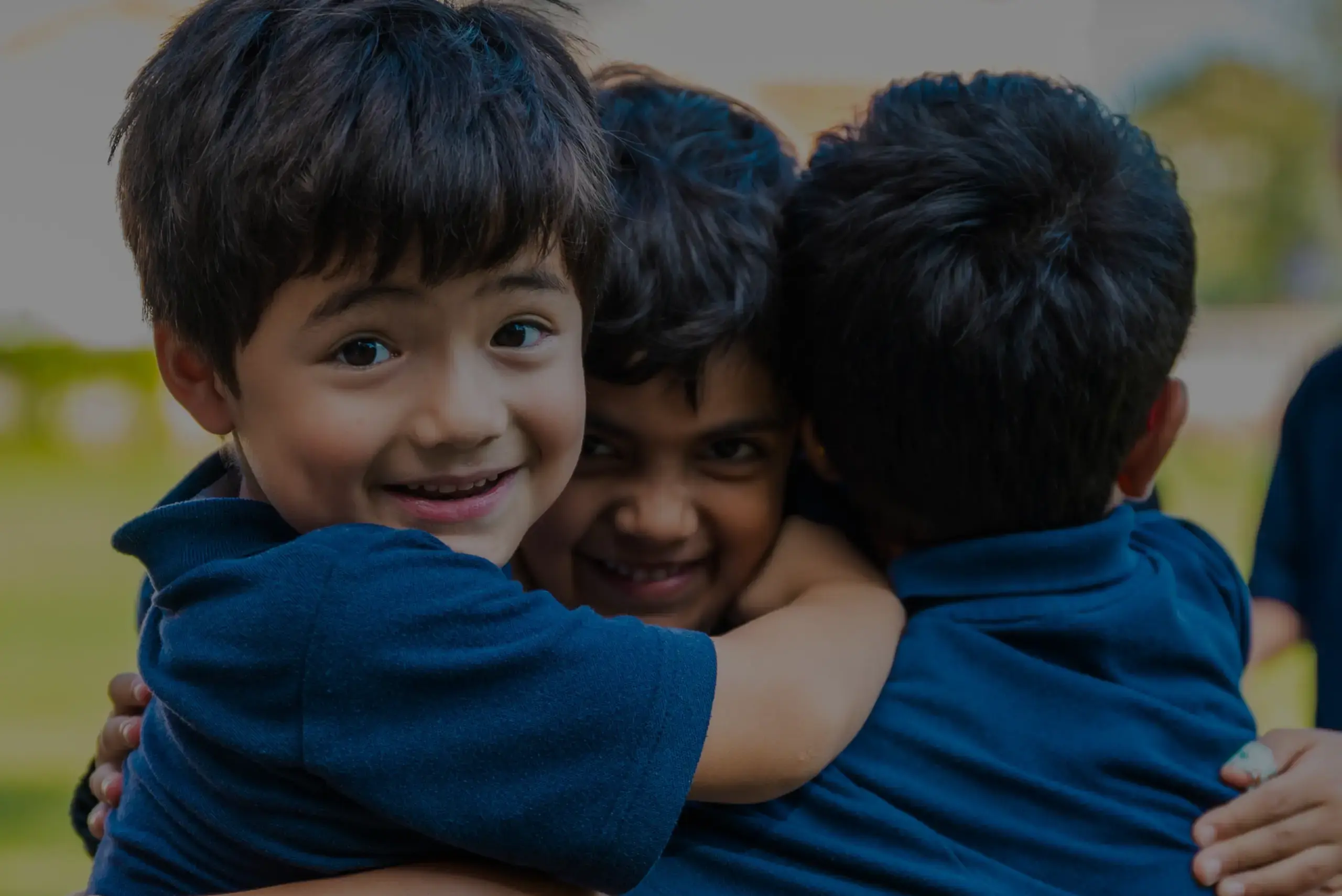 Three students embracing