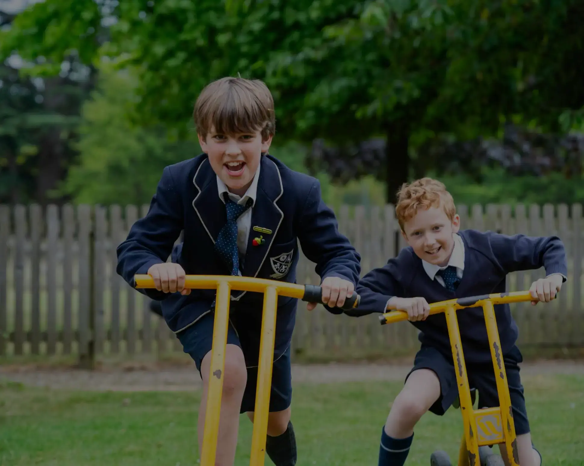 Students laughing astride playground equipment