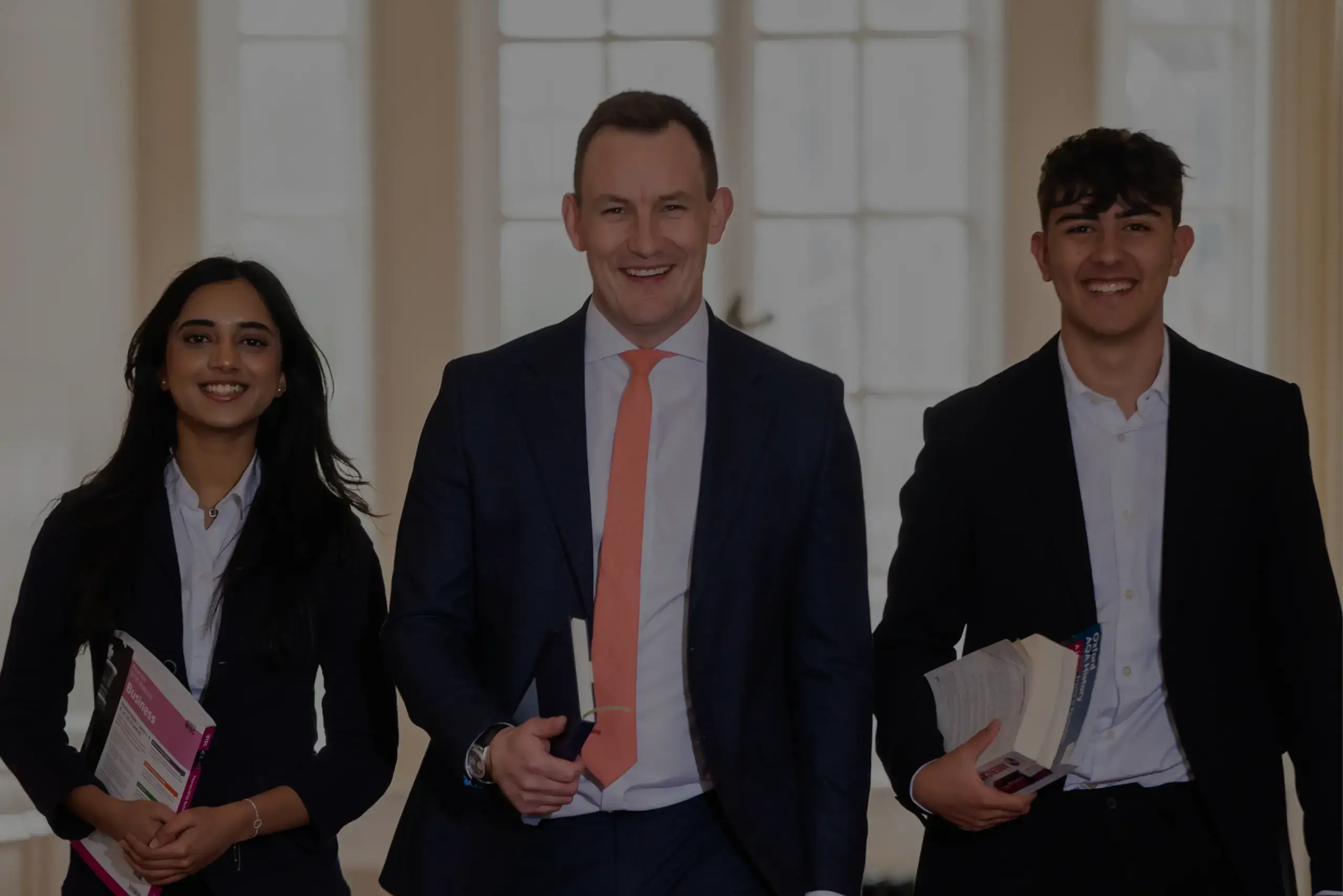 Sixth Formers smiling, walking towards camera