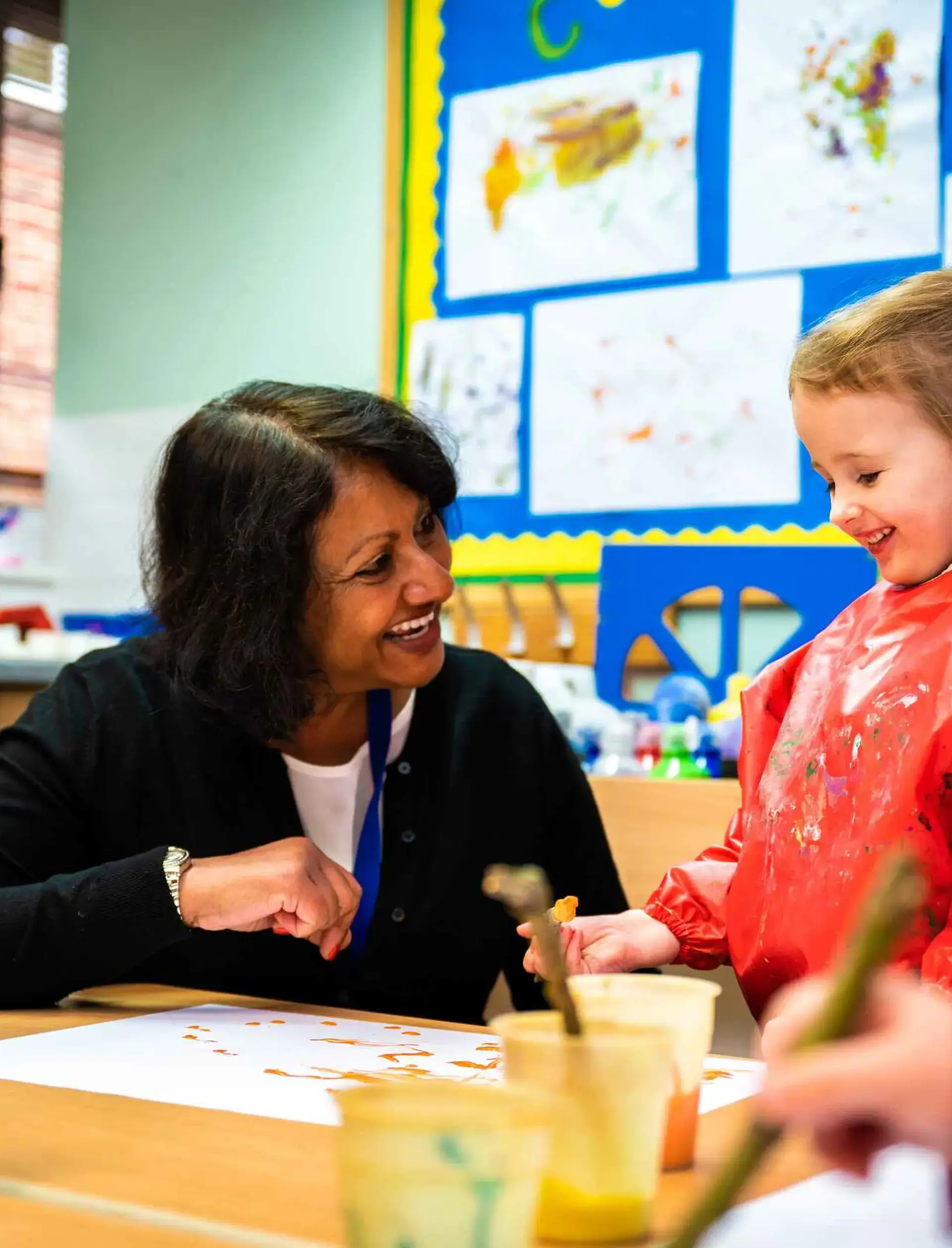 Student and teacher smiling