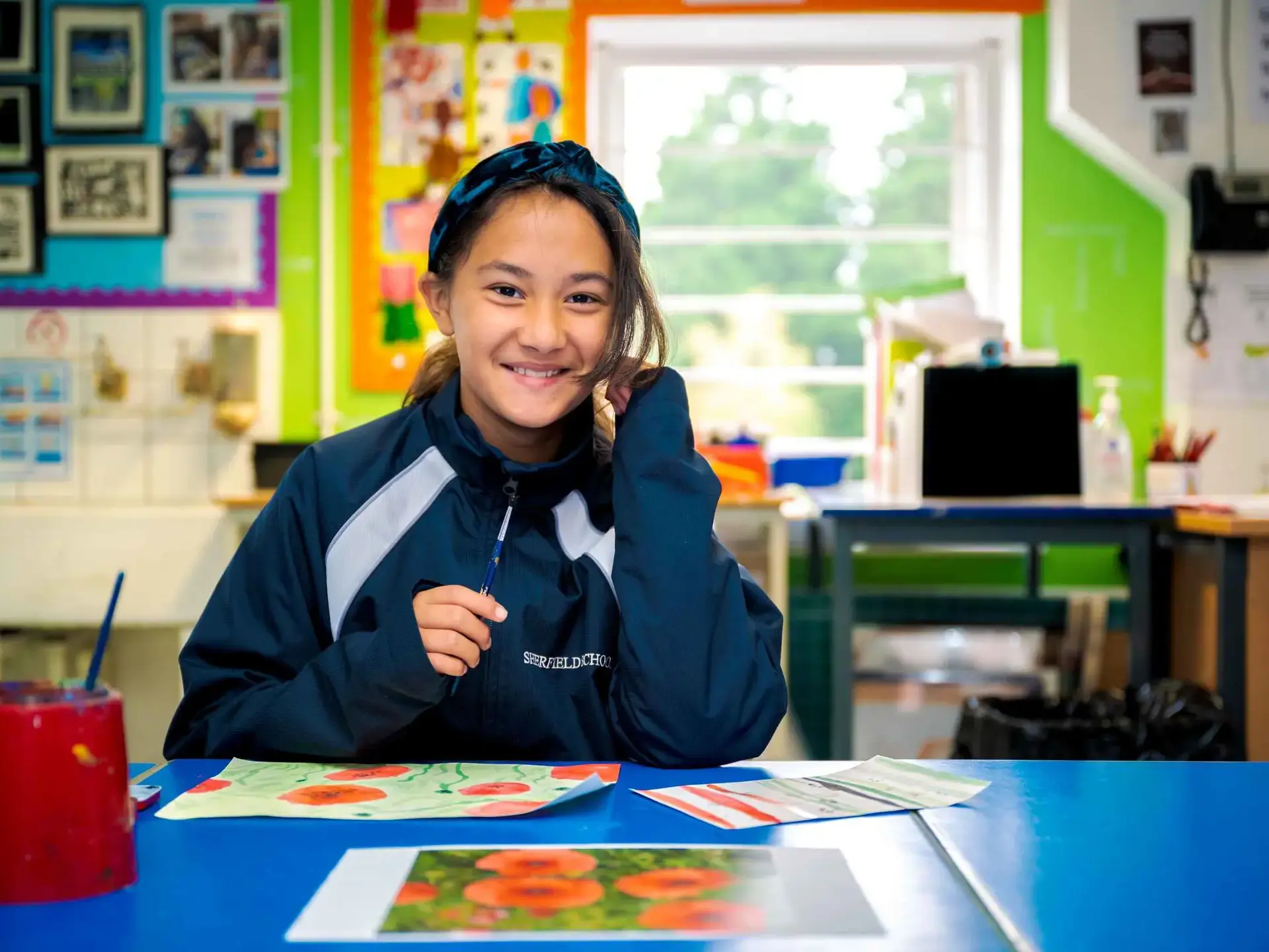 Student sitting at table and smiling