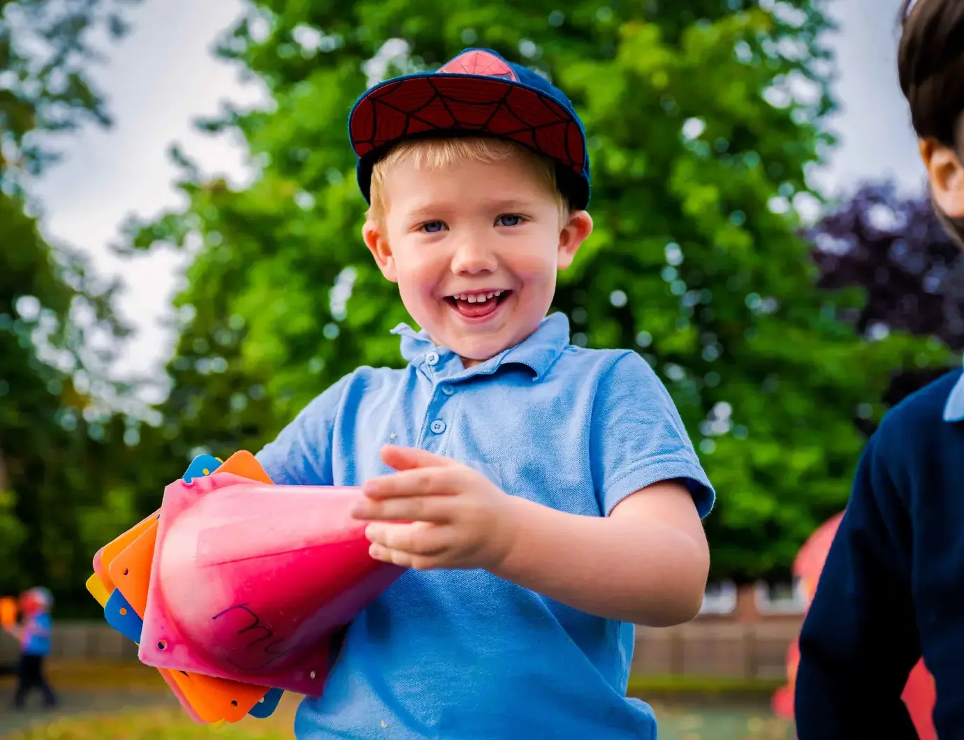 Smiling student holding cones