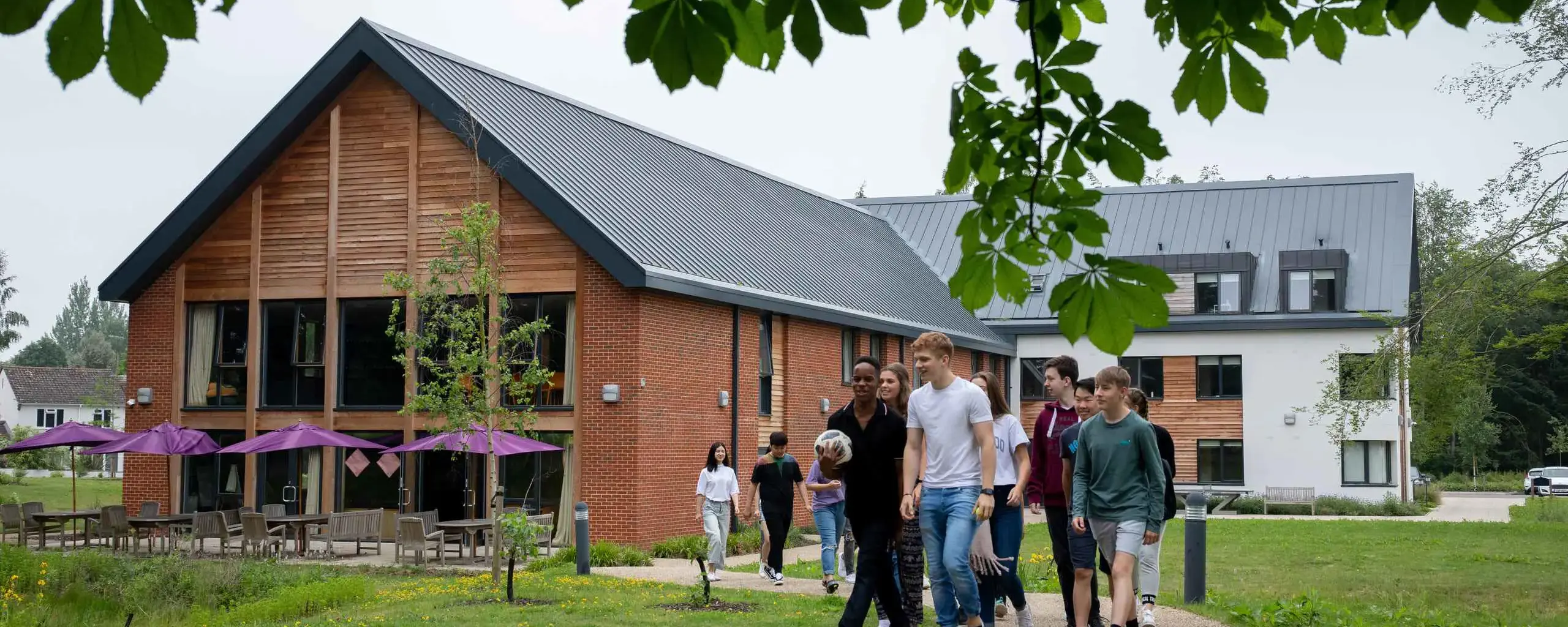 Boarders walking in front of boarding house