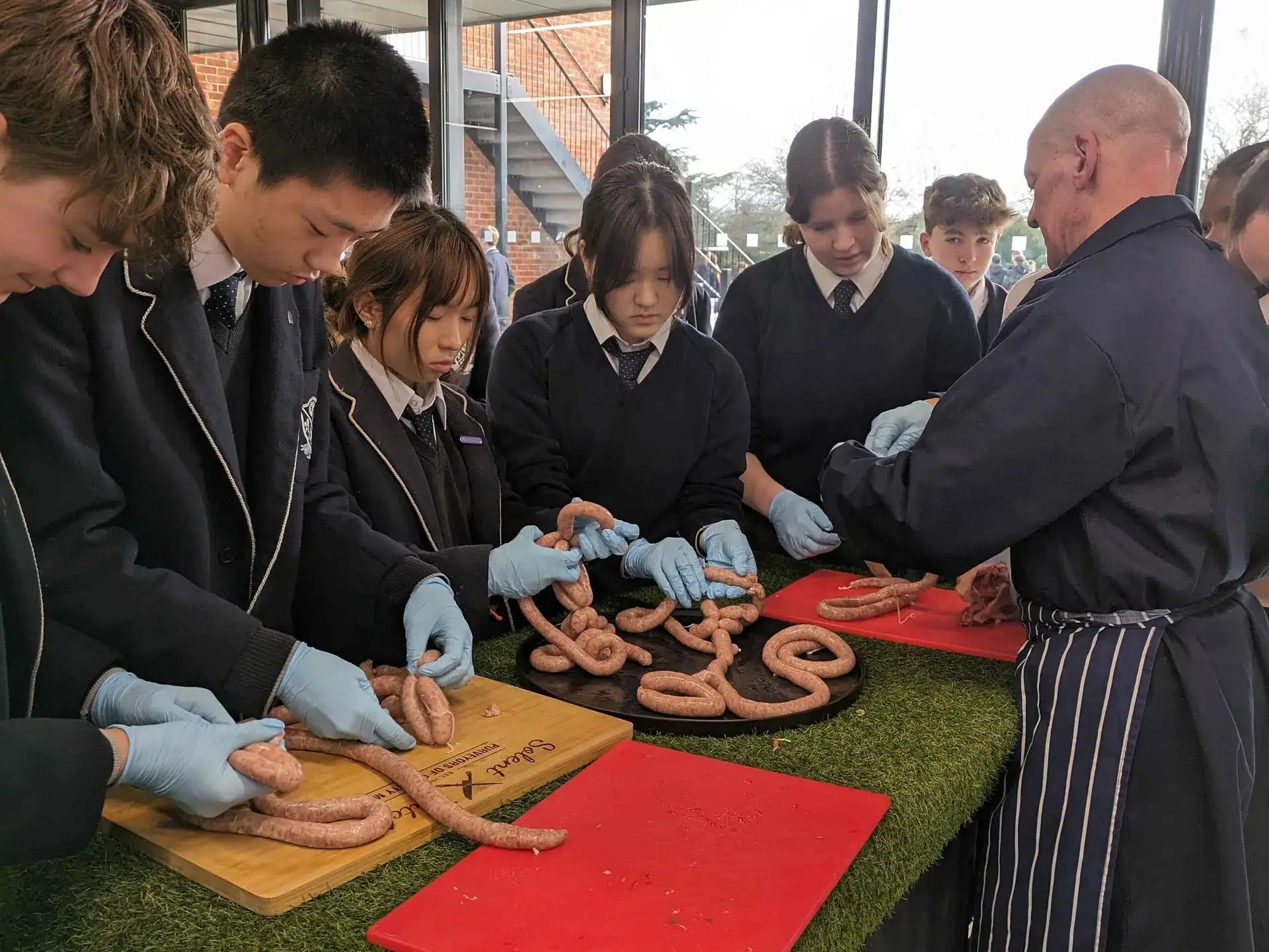 Students attending a butchering masterclass