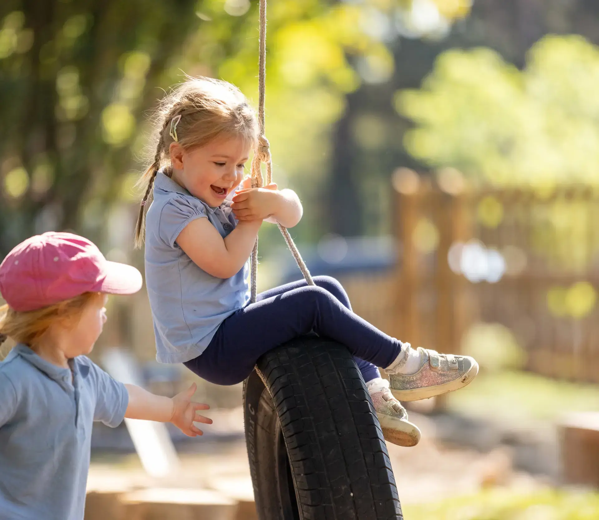 Students playing on tyre swing