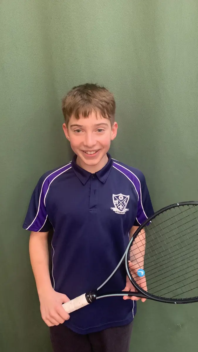 Student holding tennis racquet