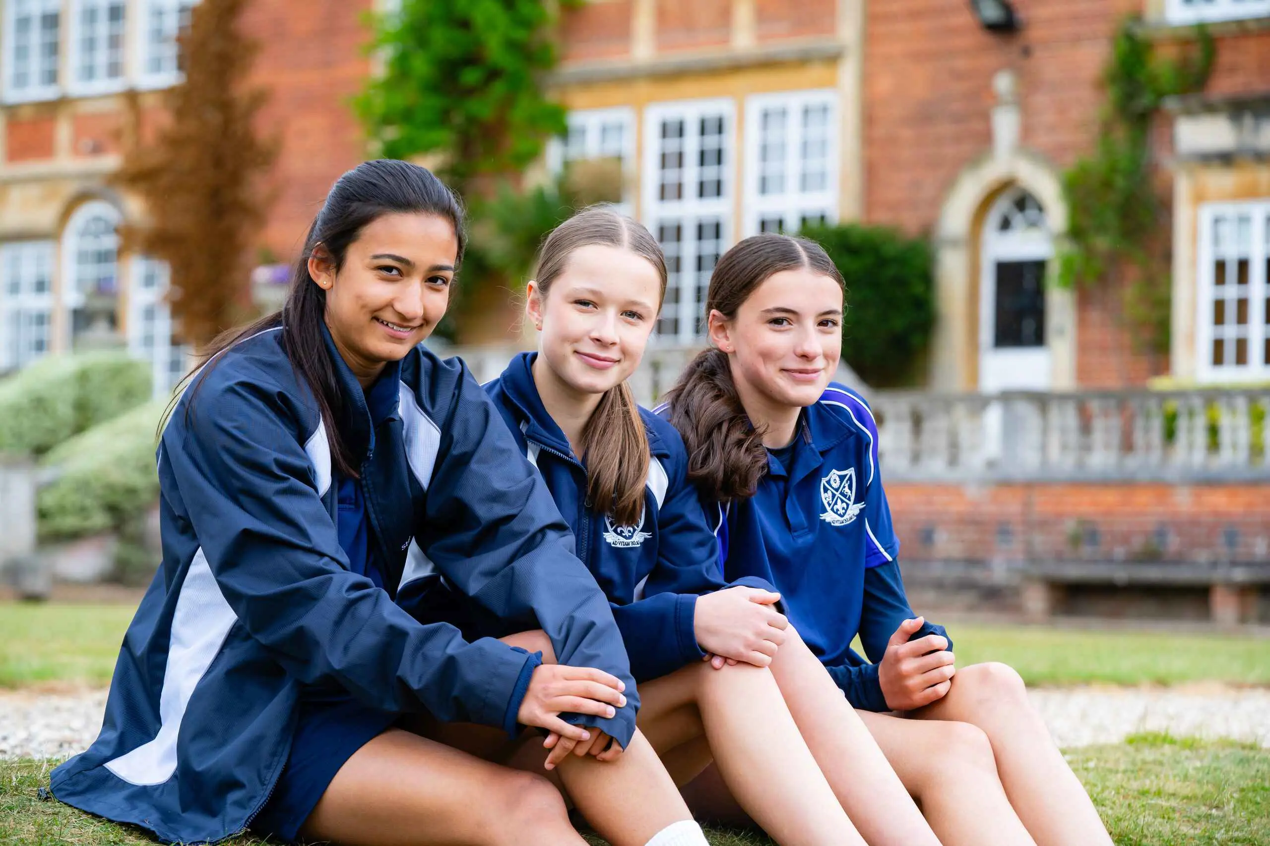 Female students sitting on school grounds