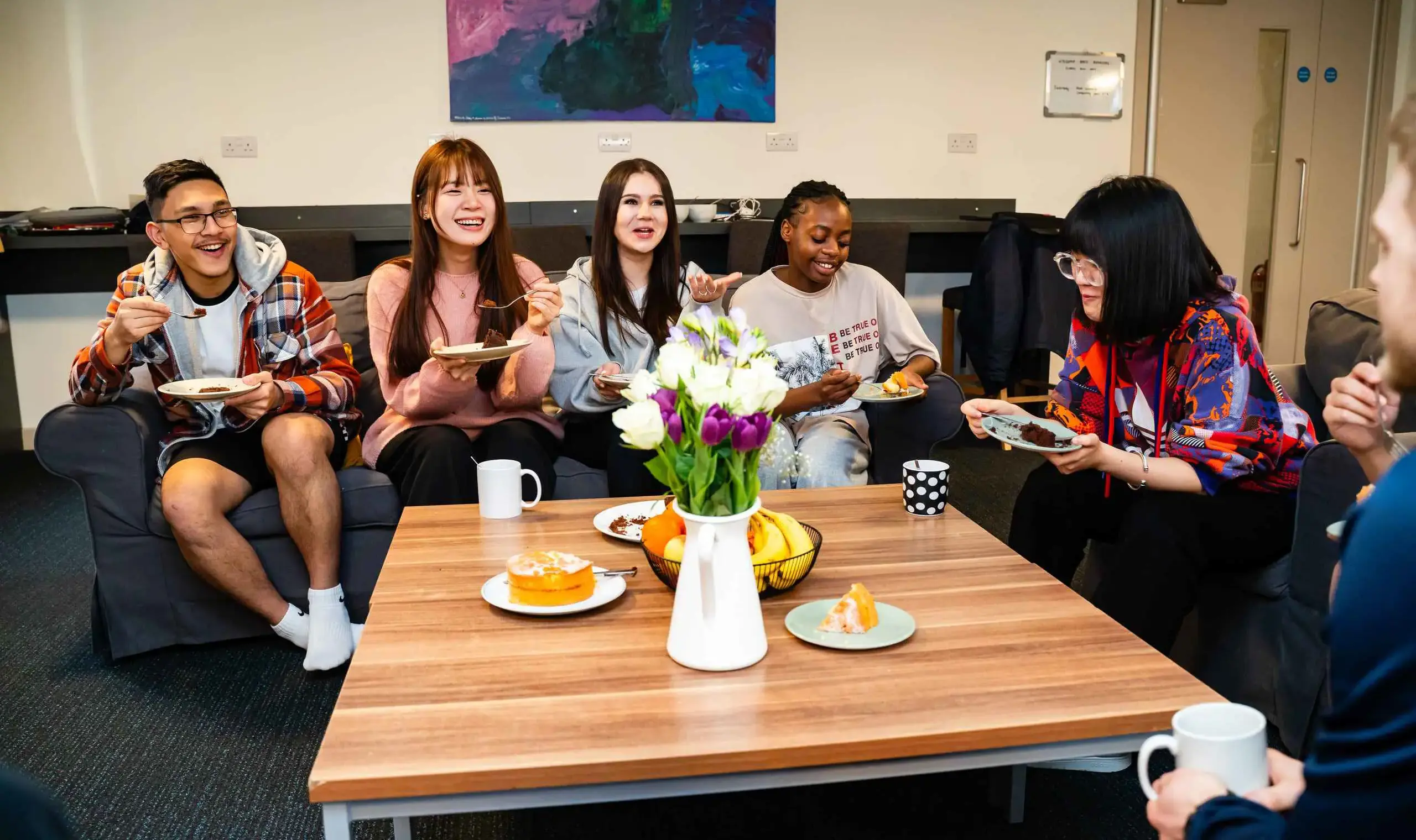Boarders laughing over plates of cake