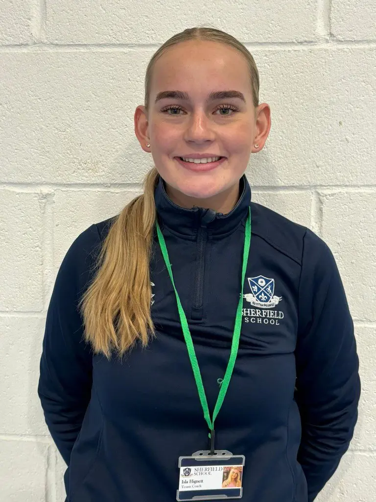 Isla Hignett standing against a white wall