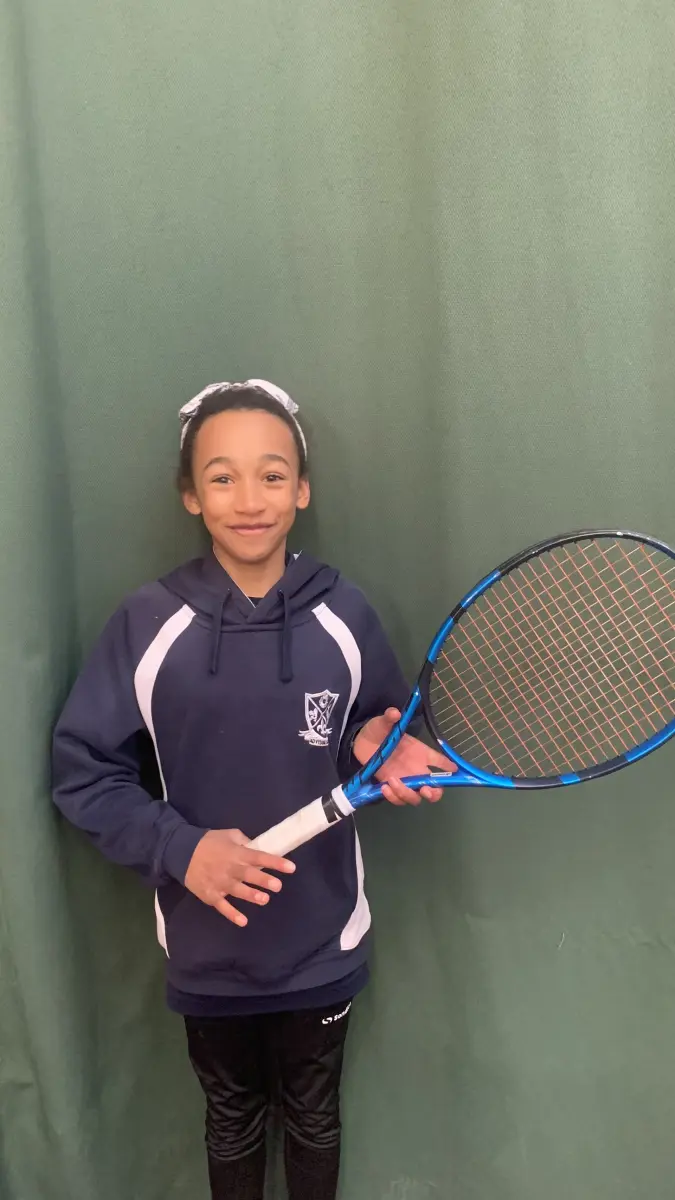 Student holding tennis racquet
