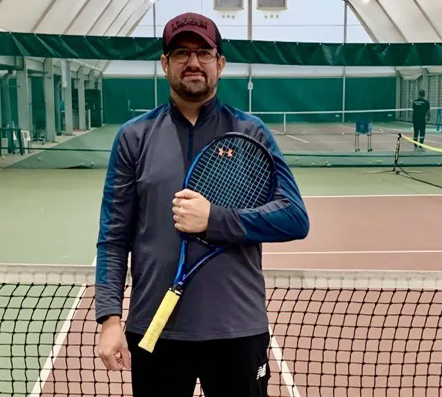 Kevin Tucker holding a tennis racquet