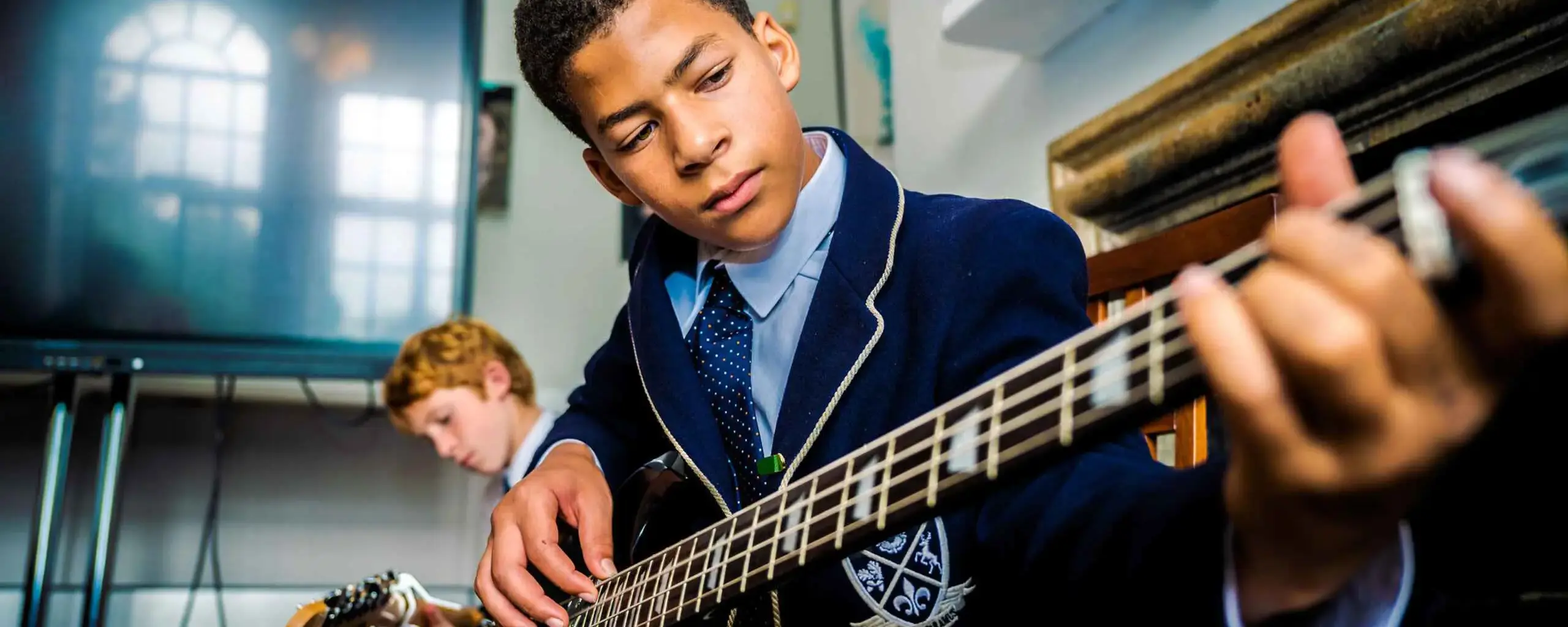 Pupil Playing Guitar