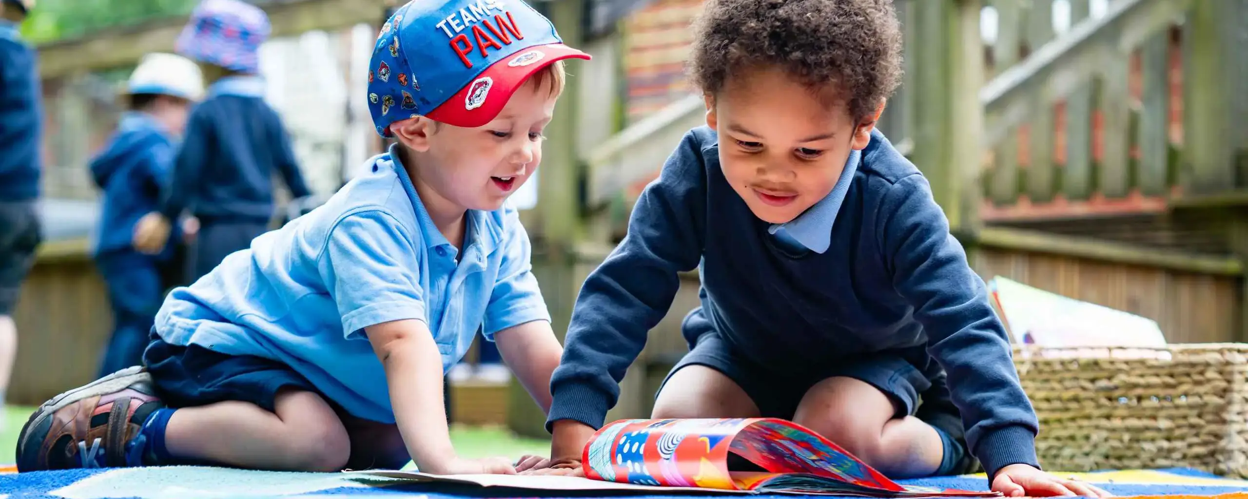 Nursery Boys Reading Outside