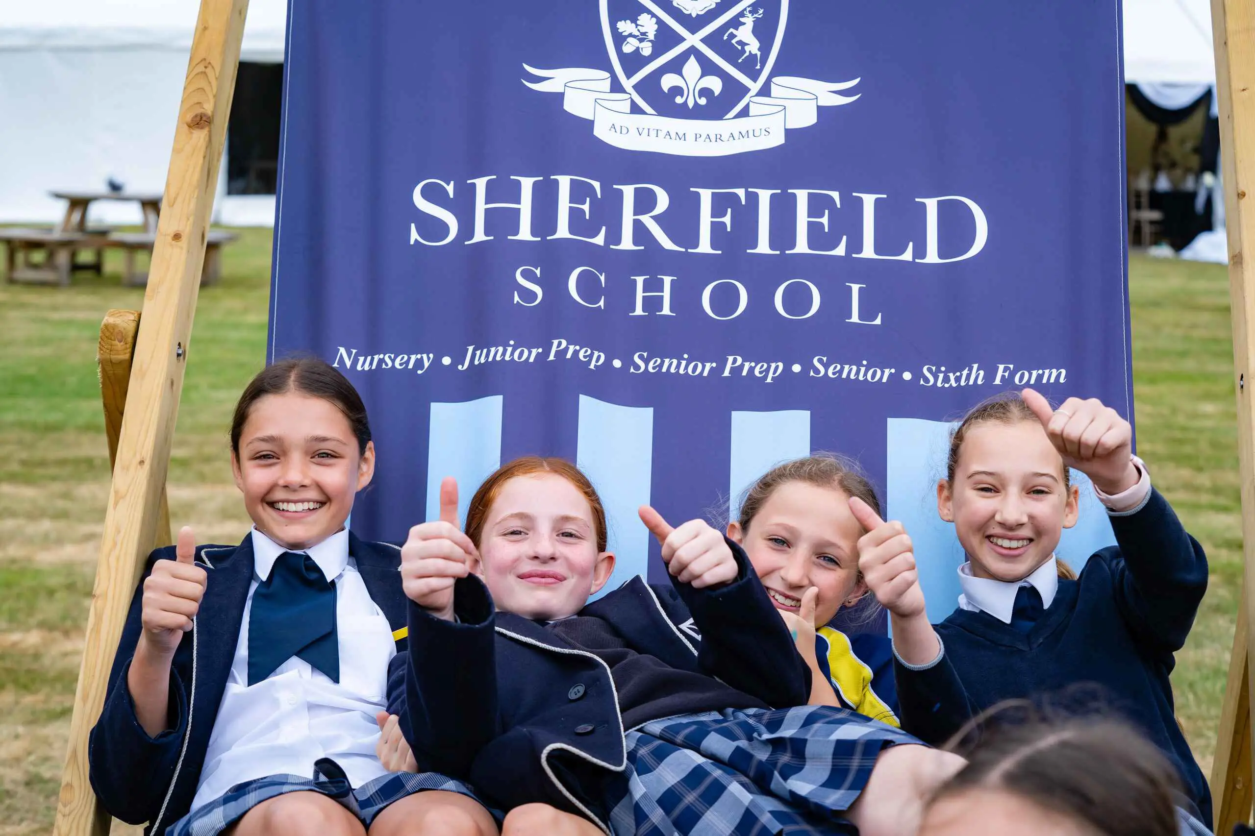 Students sitting on Sherfield chair on school grounds