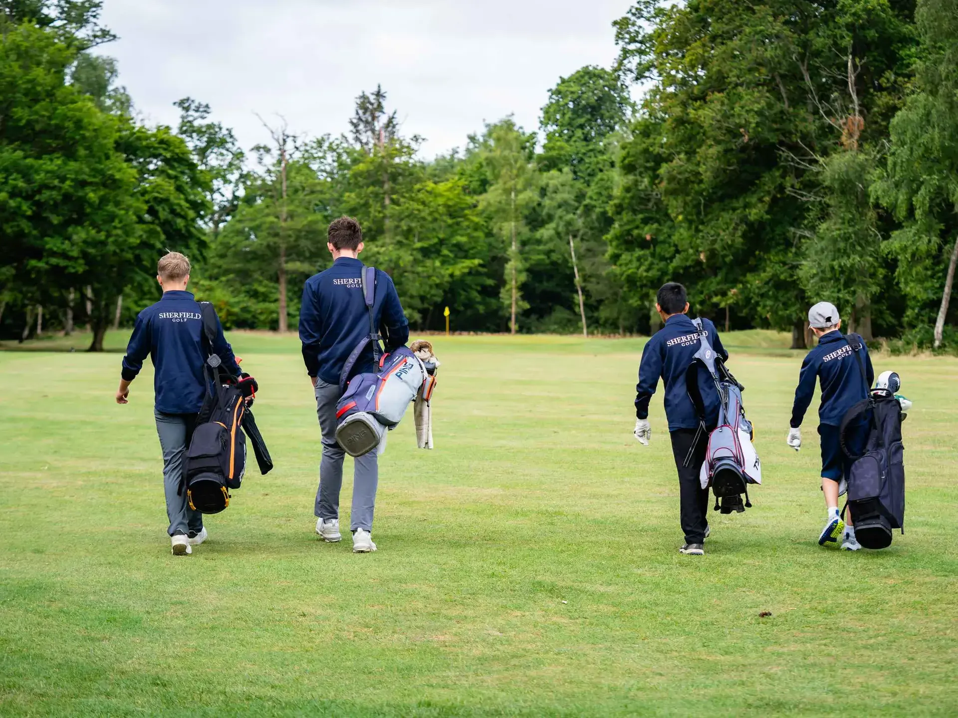 Golf players walking across green