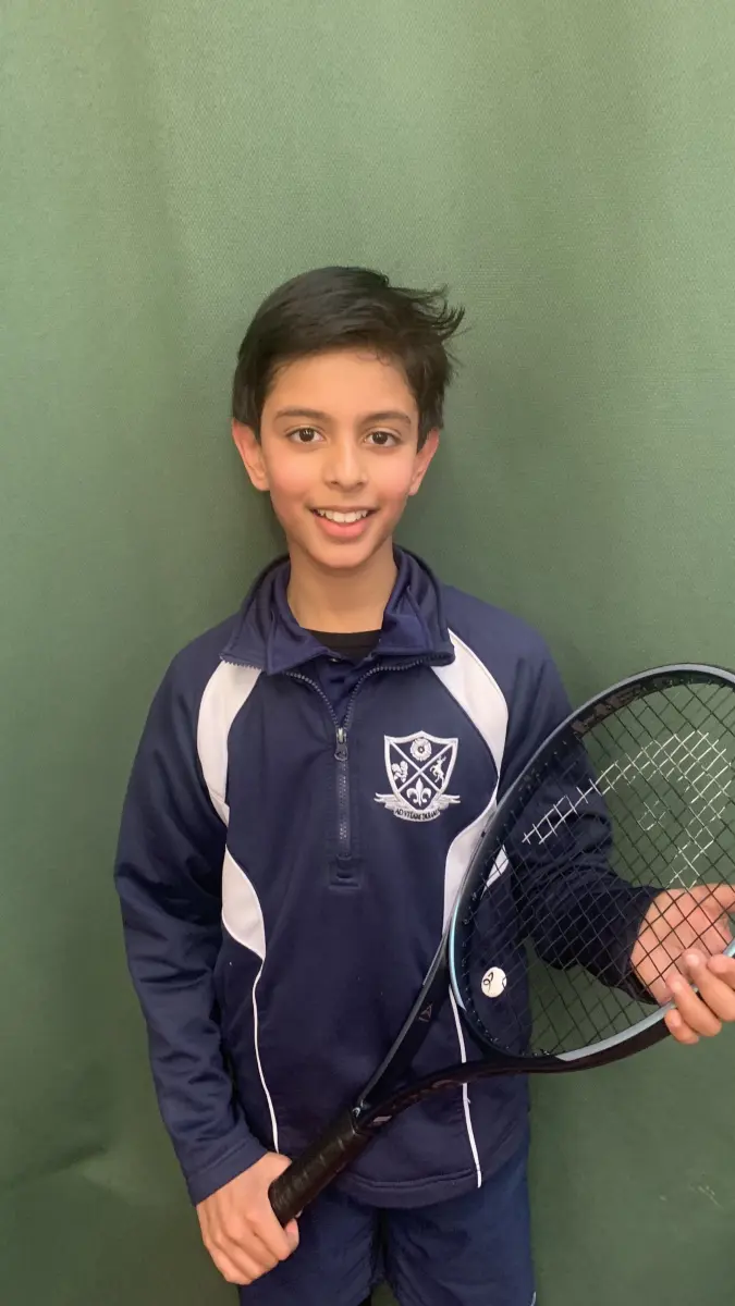 Student holding tennis racquet