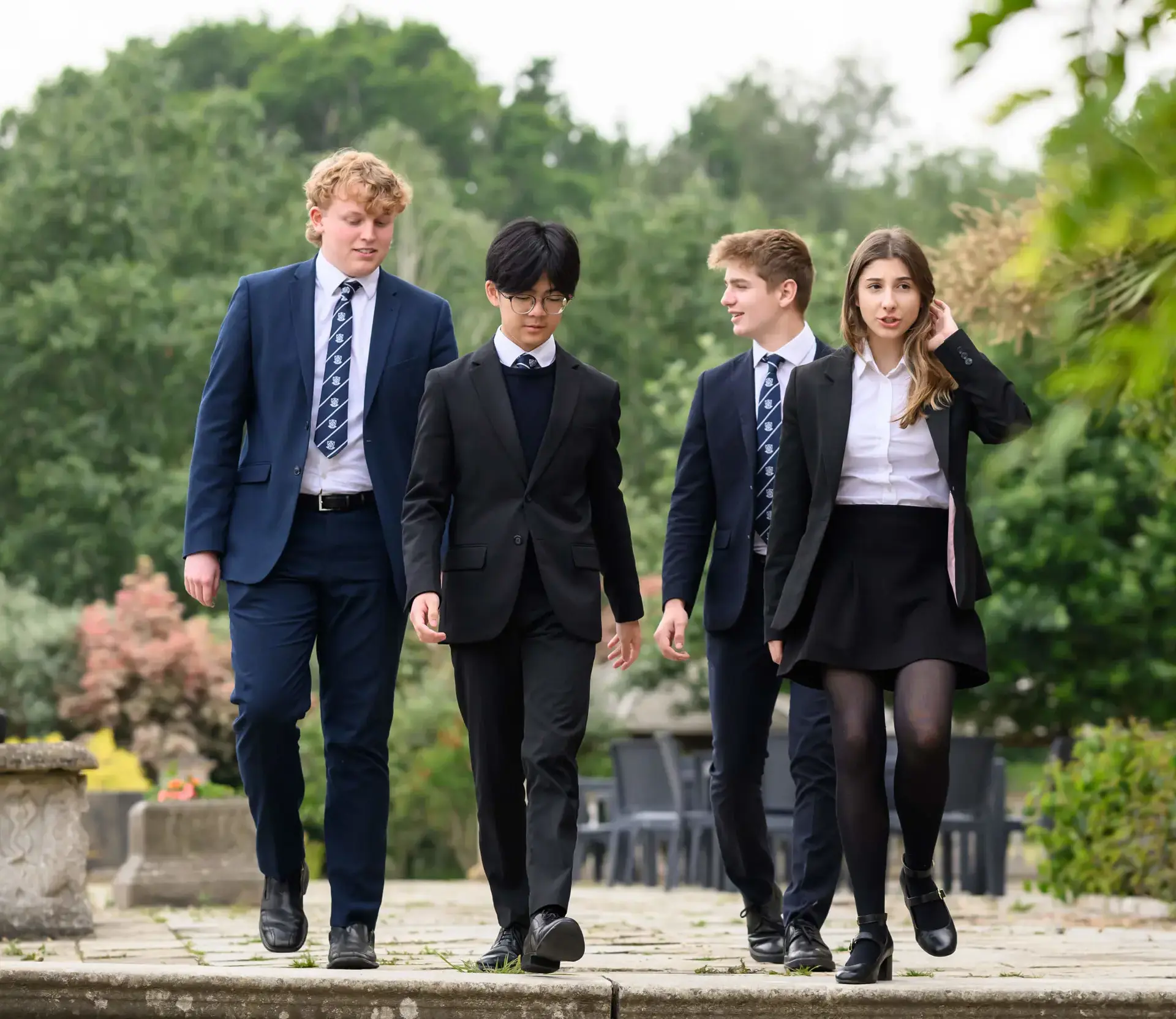 Four Sixth Formers walking towards camera