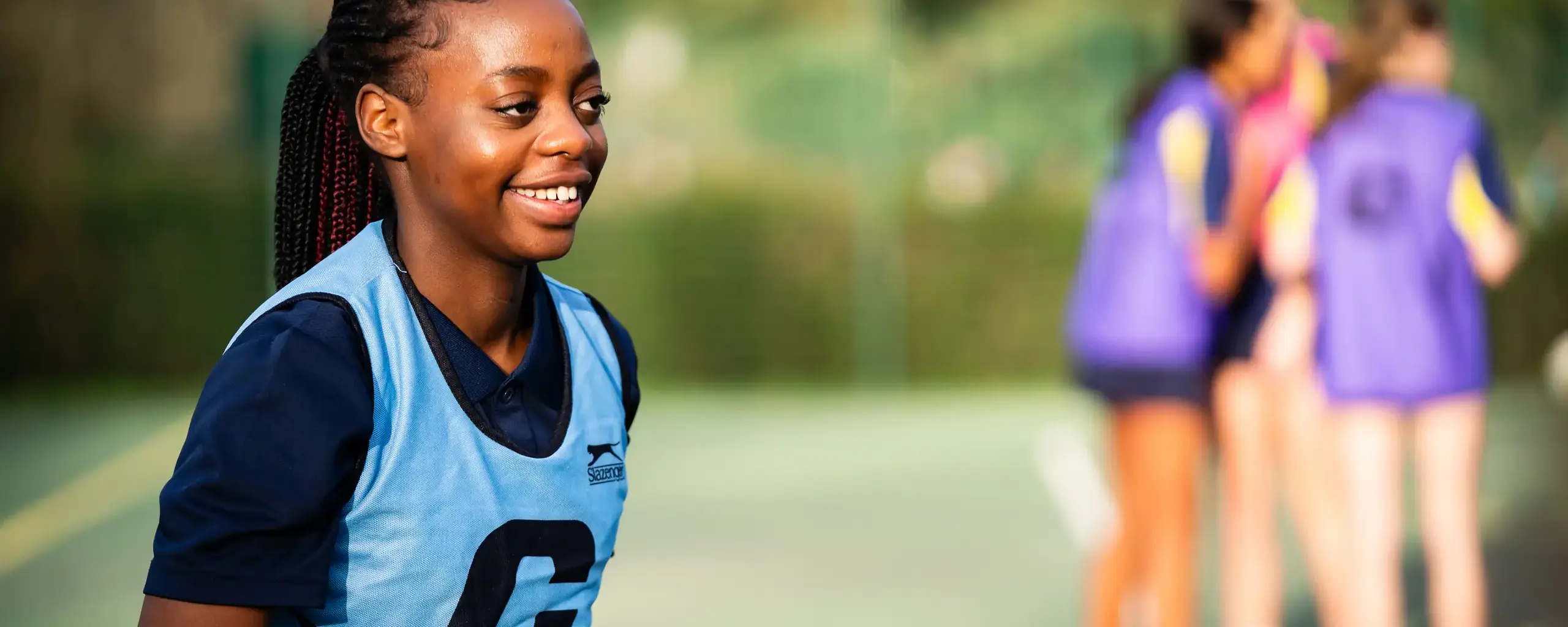 Sixth Form Student Playing Netball