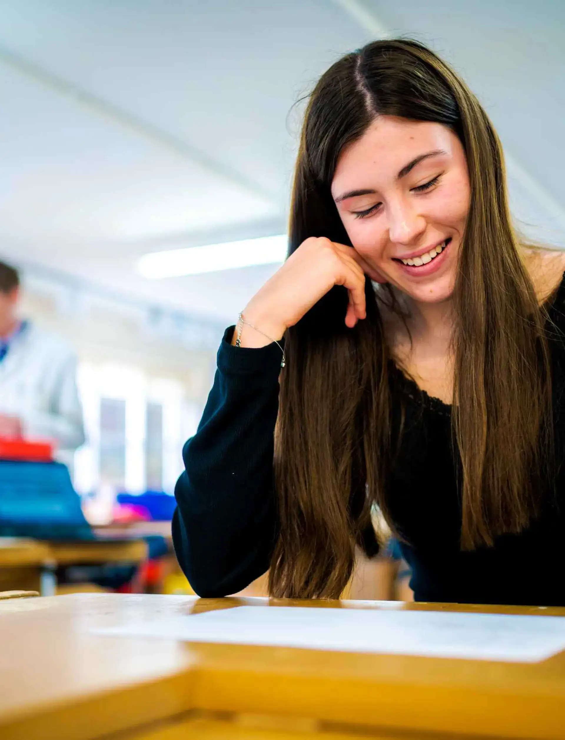 Student writing on a piece of paper