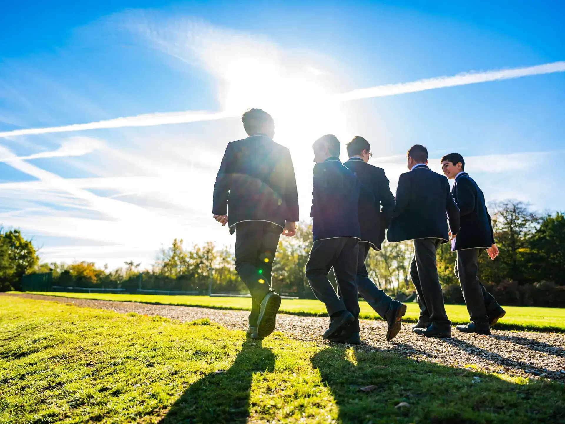 Students walking away in sunshine
