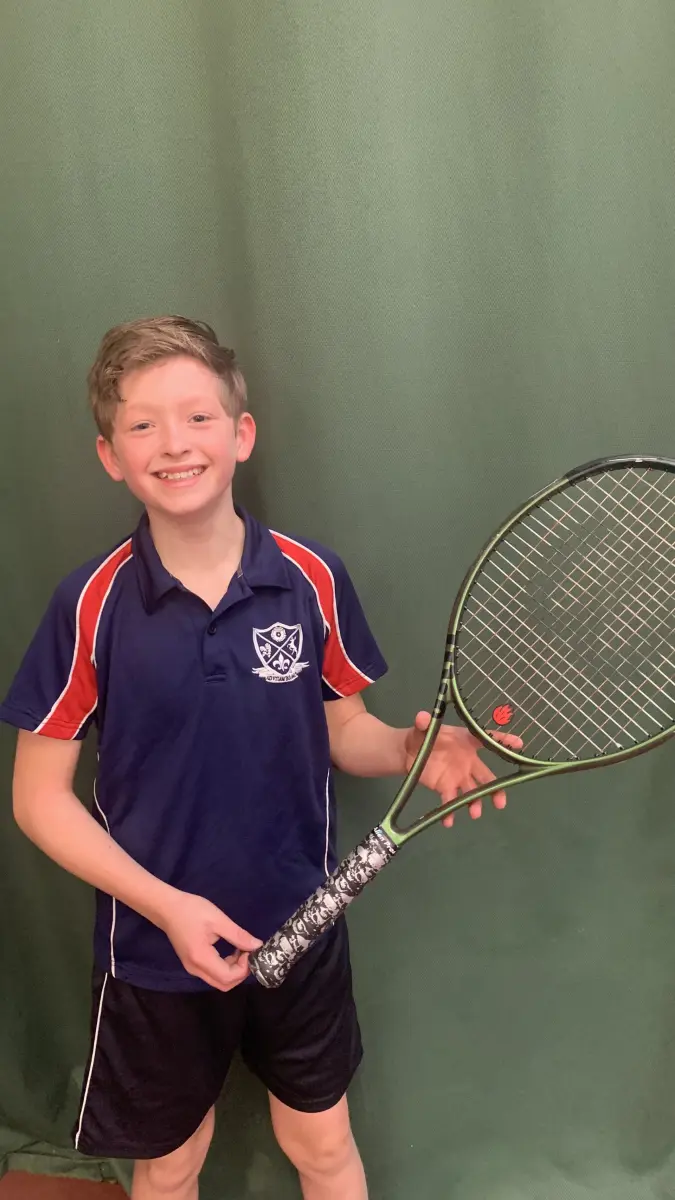Student holding tennis racquet